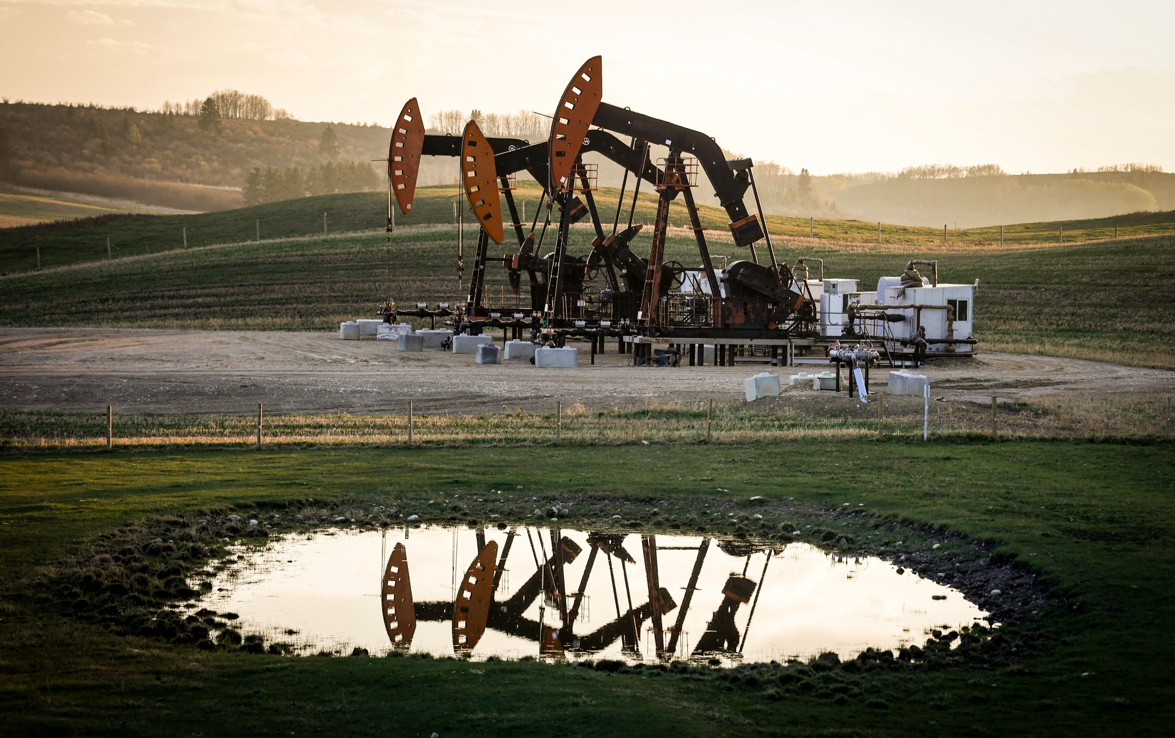 FILE - Pumpjacks operate as wildfire smoke hangs in the air near Calgary, Alberta, May 12, 2024. (Jeff McIntosh/The Canadian Press via AP, File)