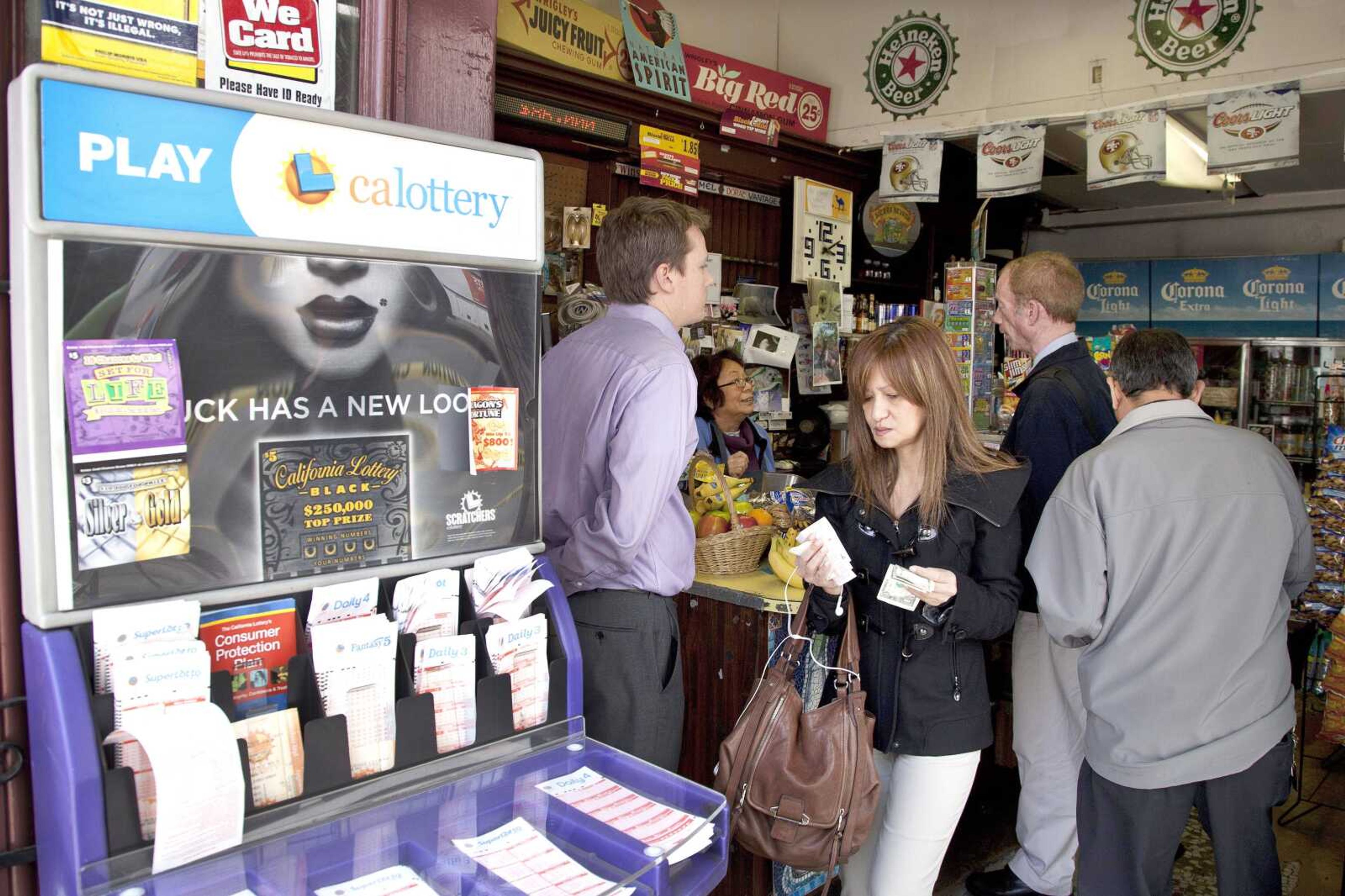 Customers wait to purchase Mega Millions lottery tickets Wednesday in San Francisco. The estimated jackpot for Friday&#8217;s drawing is now more than a half-billion dollars. (Ben Margot ~ Associated Press)