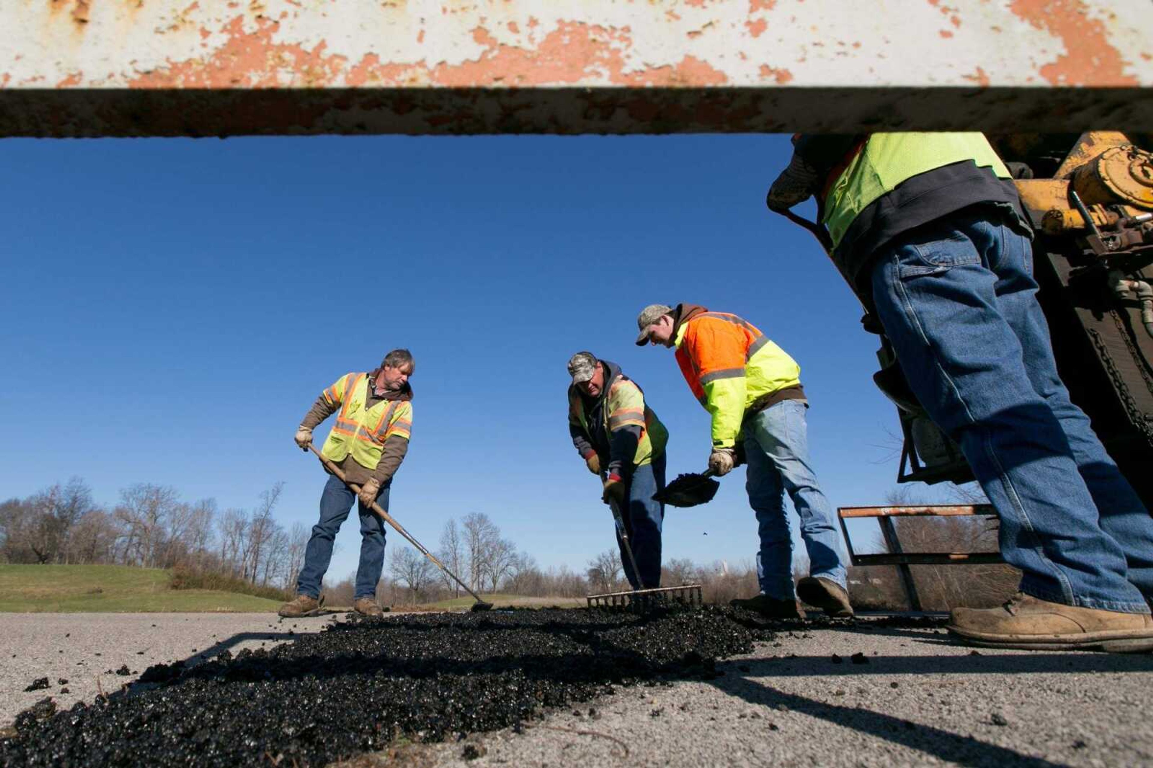 Michael Shovan, Jonathon Sinn, Jeff Petzoldt and David Ford, part of a road maintenance crew for the Cape Special Road District, repair potholes Friday along County Road 651. (Glenn Landberg)