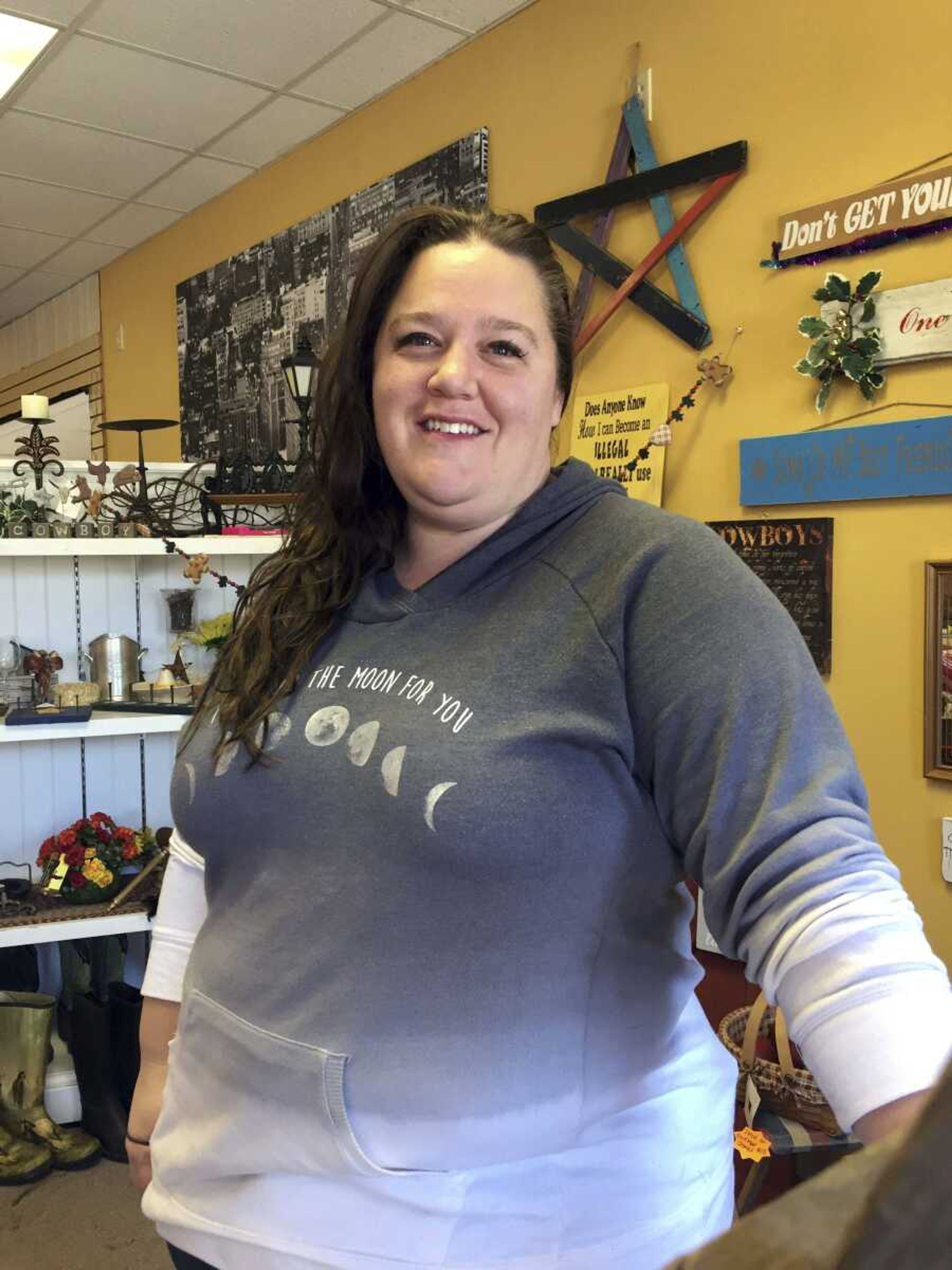 Shay Chamberlain, who voted for Donald Trump, poses for a picture in her small clothing store and boutique in Menomonie, Wisconsin.