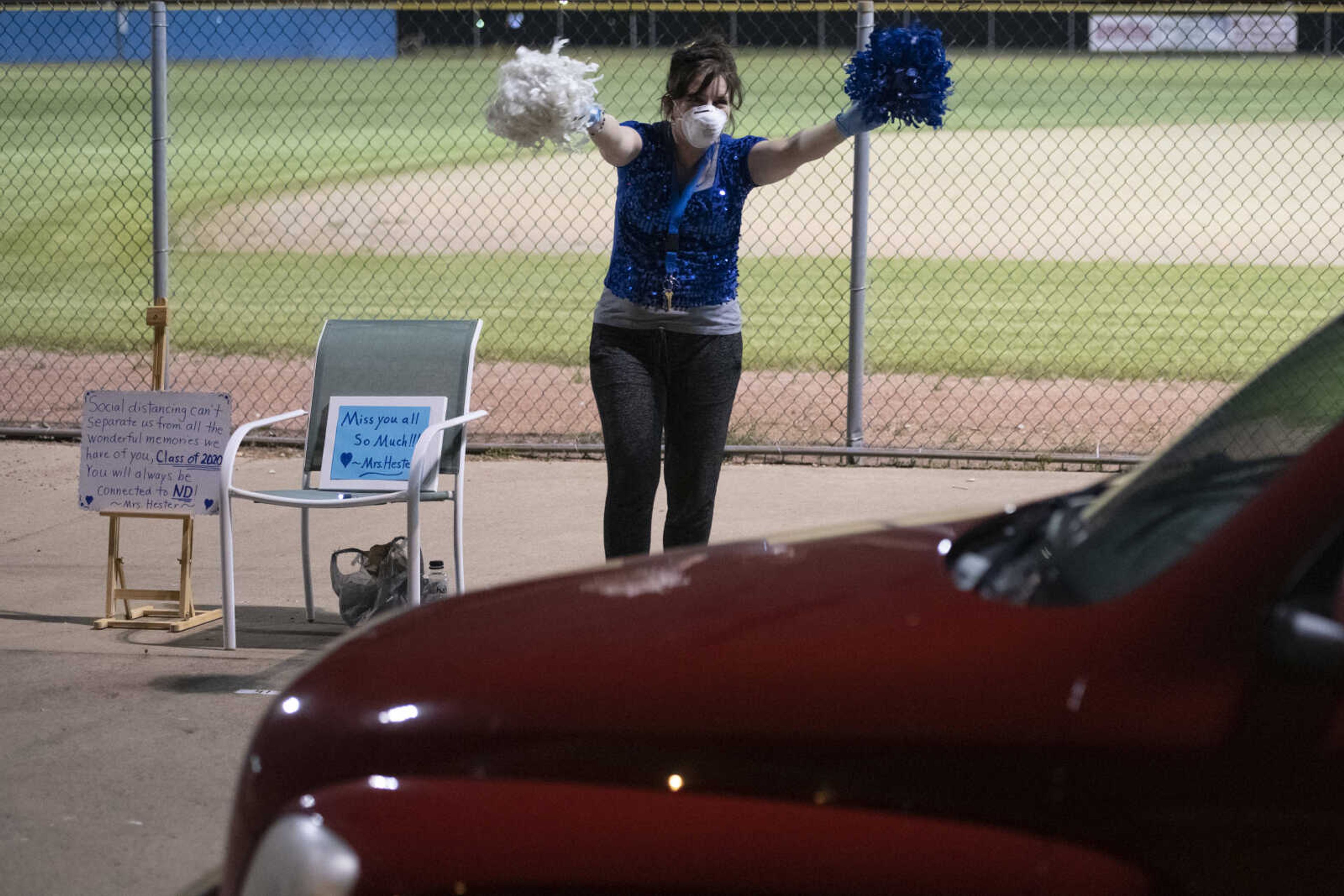 Ruth Ann Hester, a school counselor at Notre Dame Regional High School, waves during a "Friday night lights" senior drive-through event Friday, May 1, 2020, at the Cape Girardeau school.