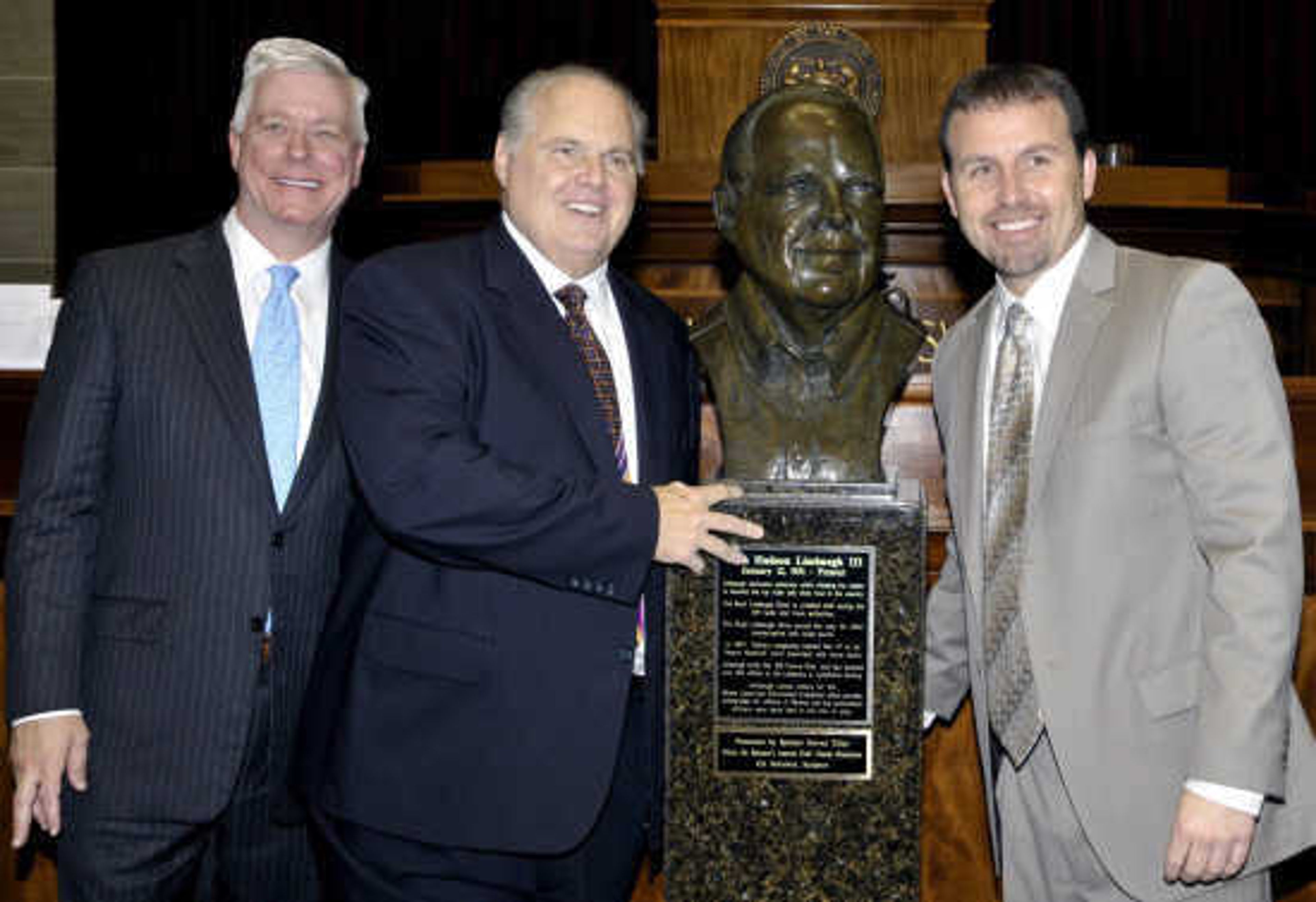 Lt. Gov Peter Kinder, left, and Speaker of the House, Steven Tilley, right, pose with conservative commentator Rush Limbaugh and a bust in Limbaugh's likeness during a ceremony inducting Limbaugh into the Hall of Famous Missourians on Monday, May 14, 2012, in the state Capitol in Jefferson City, Mo. (AP Photo/Julie Smith)