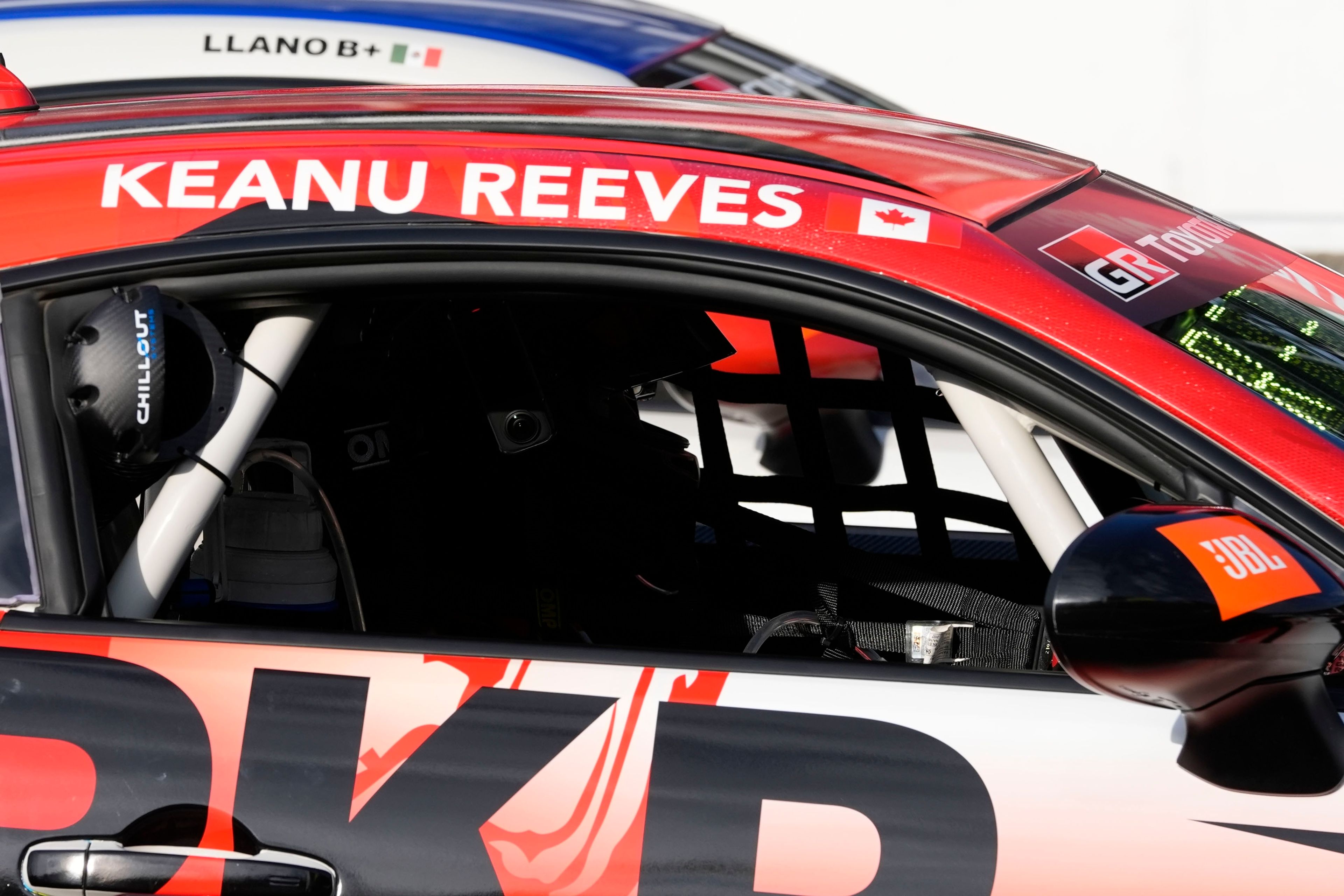 Keanu Reeves sits in his car before a GR Cup Series auto race at Indianapolis Motor Speedway, Saturday, Oct. 5, 2024, in Indianapolis. (AP Photo/Darron Cummings)