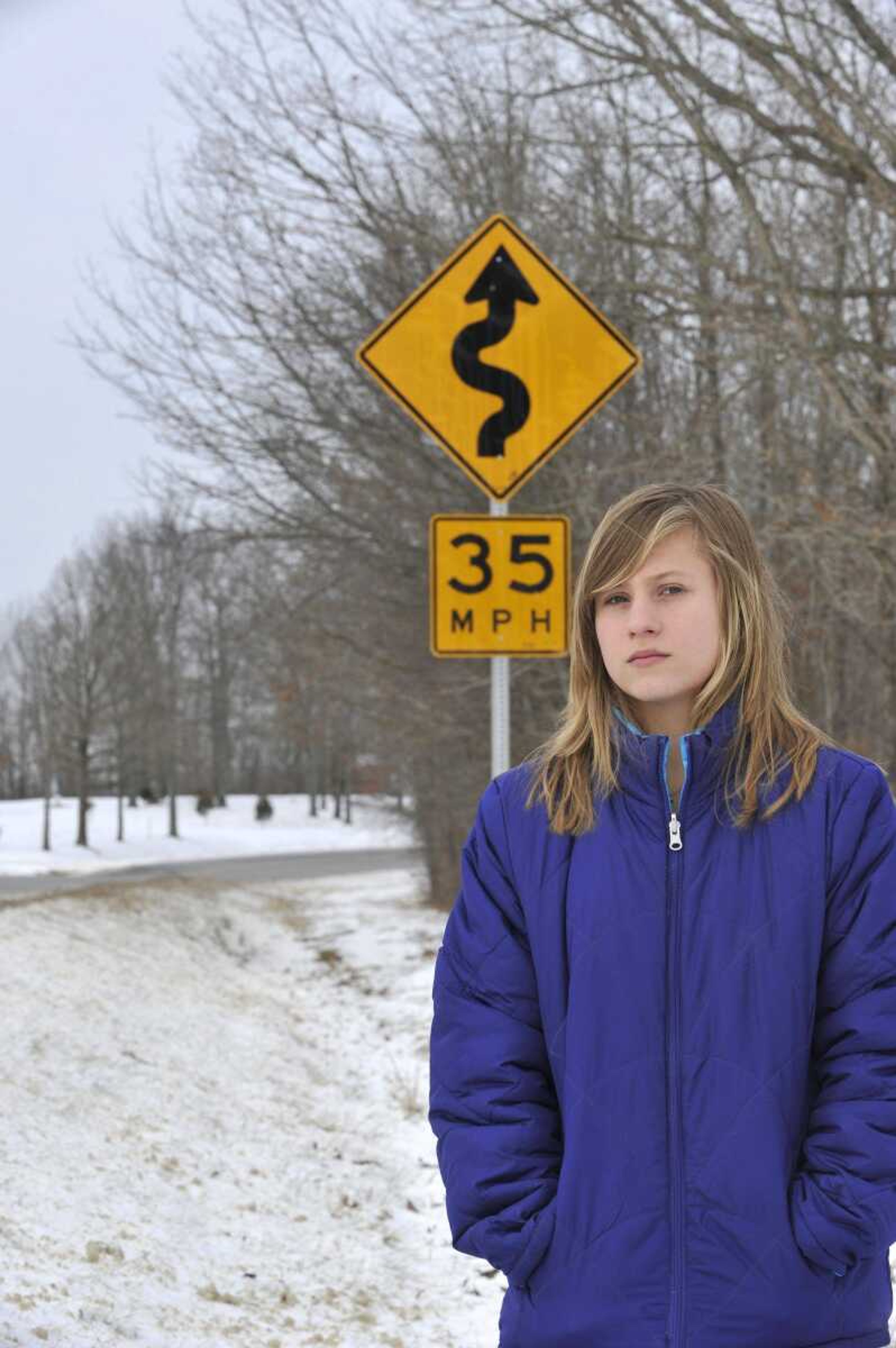 Brittany Holmes stands near Highway 51 north of Marble Hill, Mo. Her friend, Lauren Rhodes, died in a one-vehicle accident on the highway. (Fred Lynch)