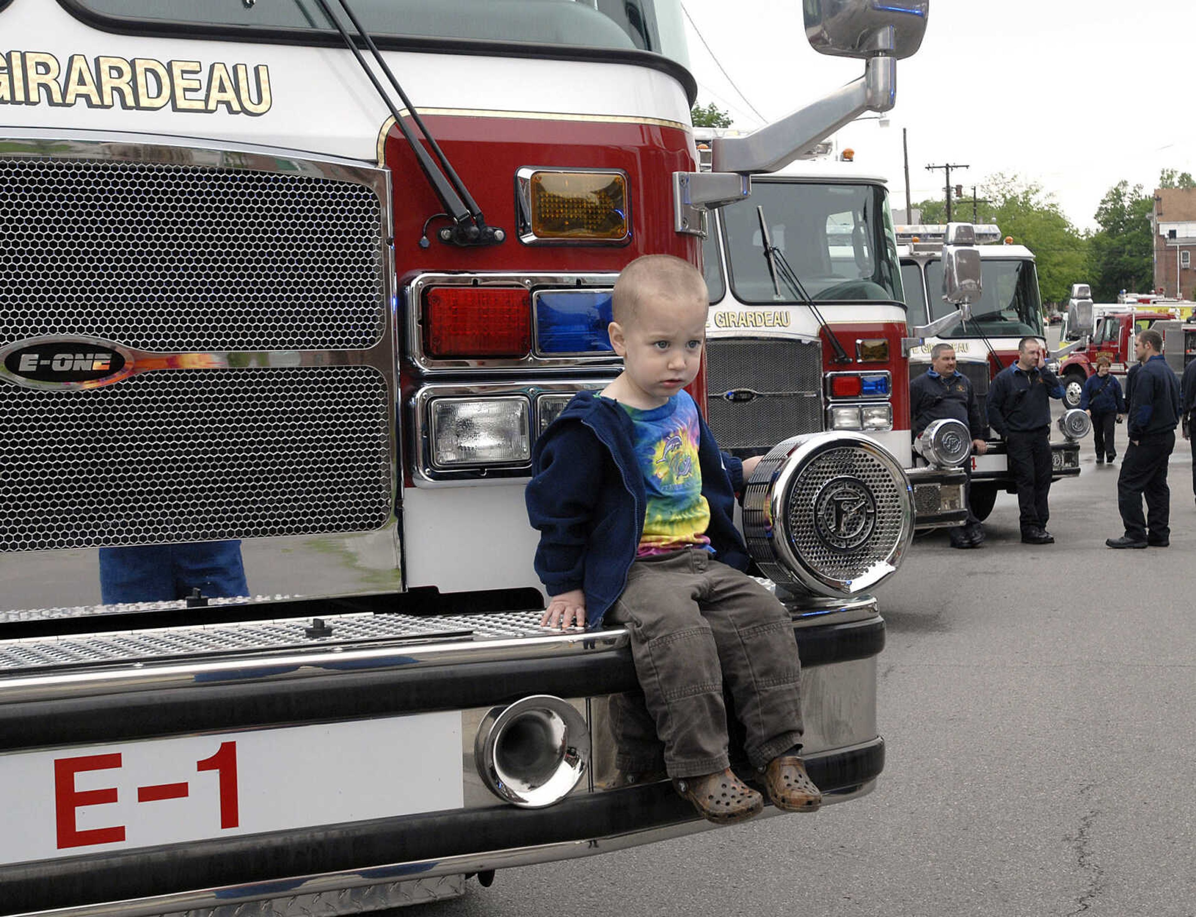 Devon Schmidt, 2, poses for a photo on a fire engine.