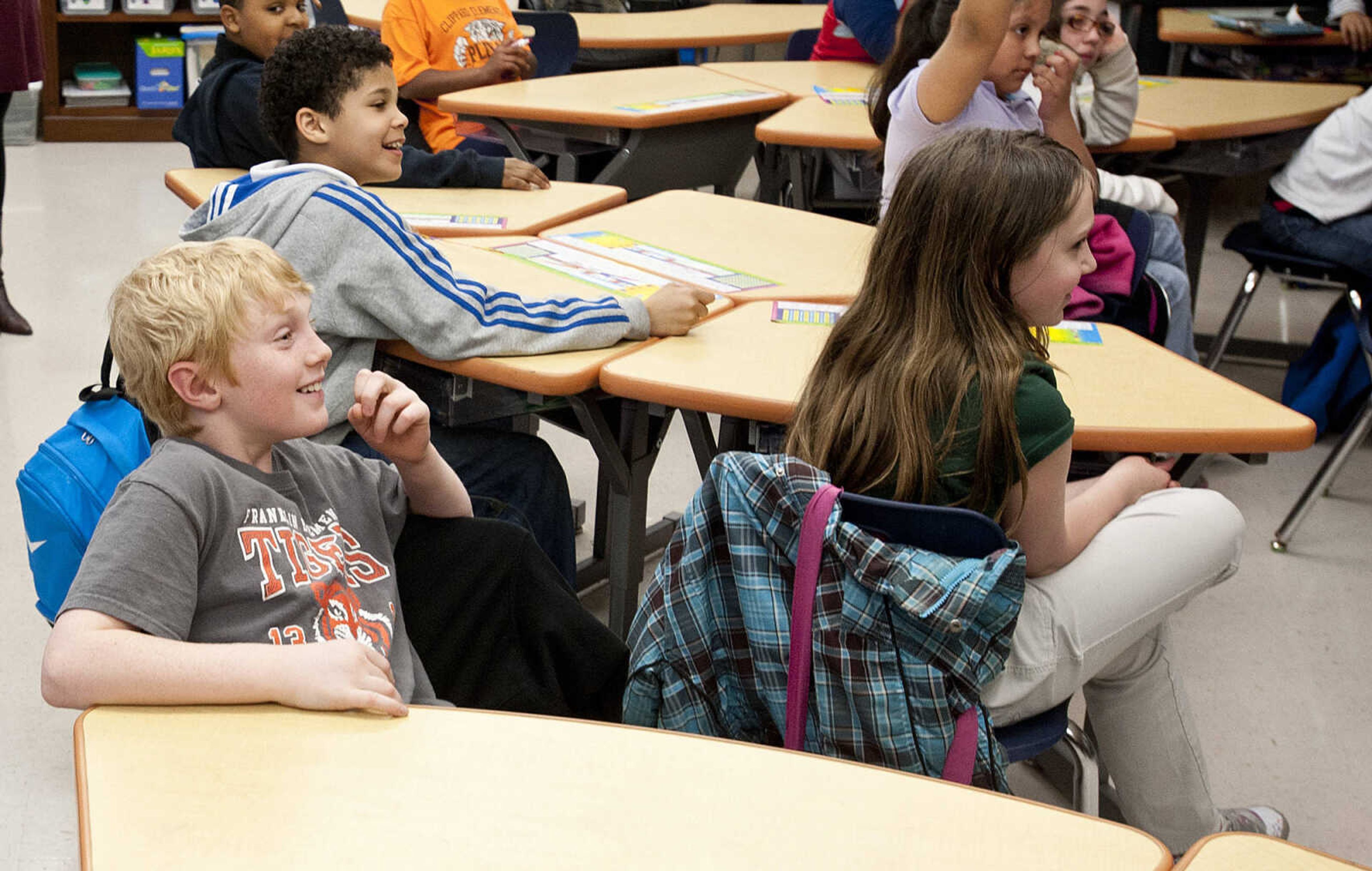 Eli Weimer, 9, reacts as his father, Command Chief Master Sgt. Geoff Weimer walks into his fourth grade class, Friday, March 14, at Franklin Elementary School in Cape Girardeau. Sgt. Weimer is on leave from the Air Force after being deployed in the Middle East since Oct., and surprised his three sons, Geordan, 11, Eli, 9, and Gabriel, 6, in their respective classes.