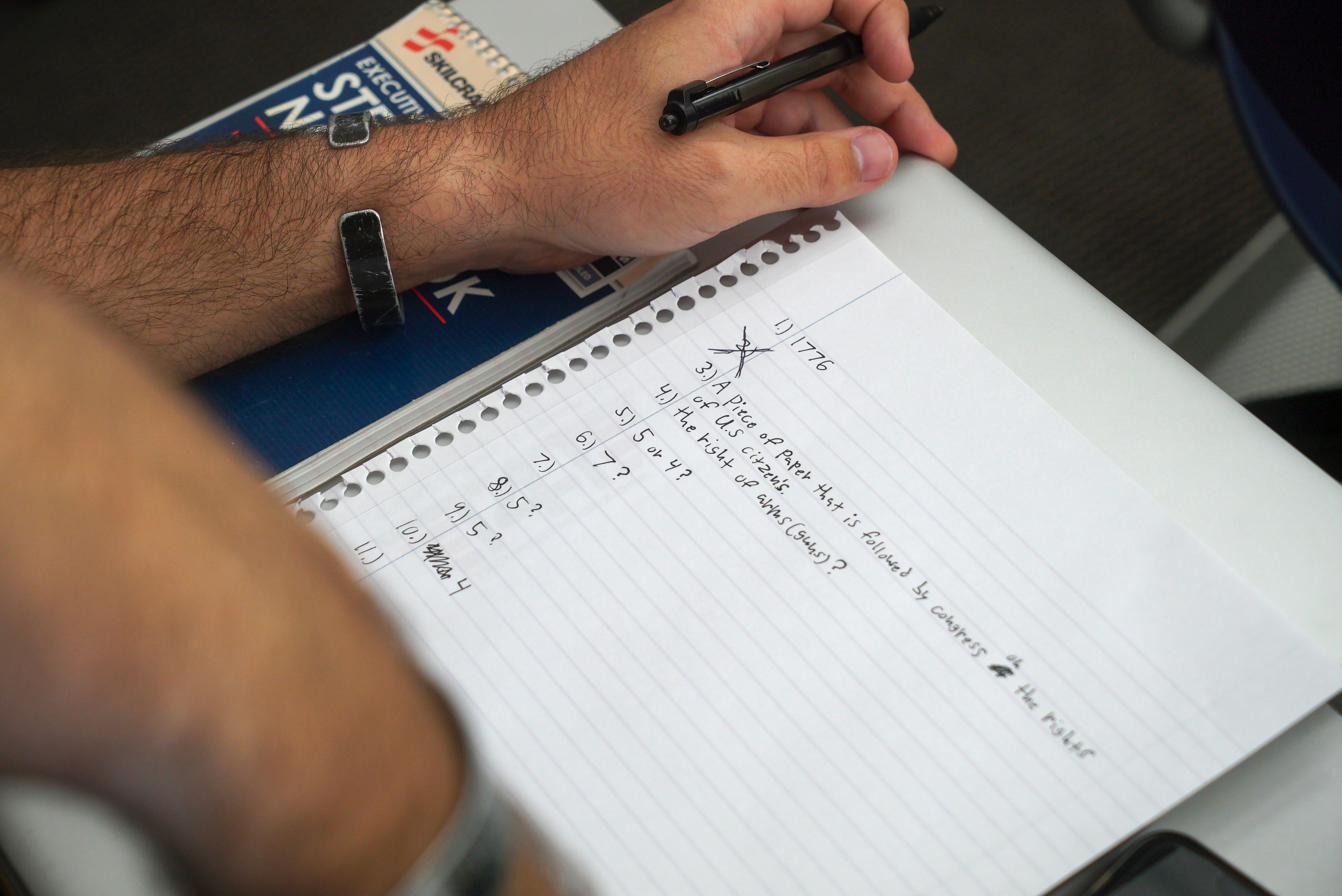 A student checks a classmate's test during an American government class at the University of South Carolina Beaufort in Bluffton, S.C., on Tuesday, Aug. 20, 2024. (AP Photo/Allen G. Breed)