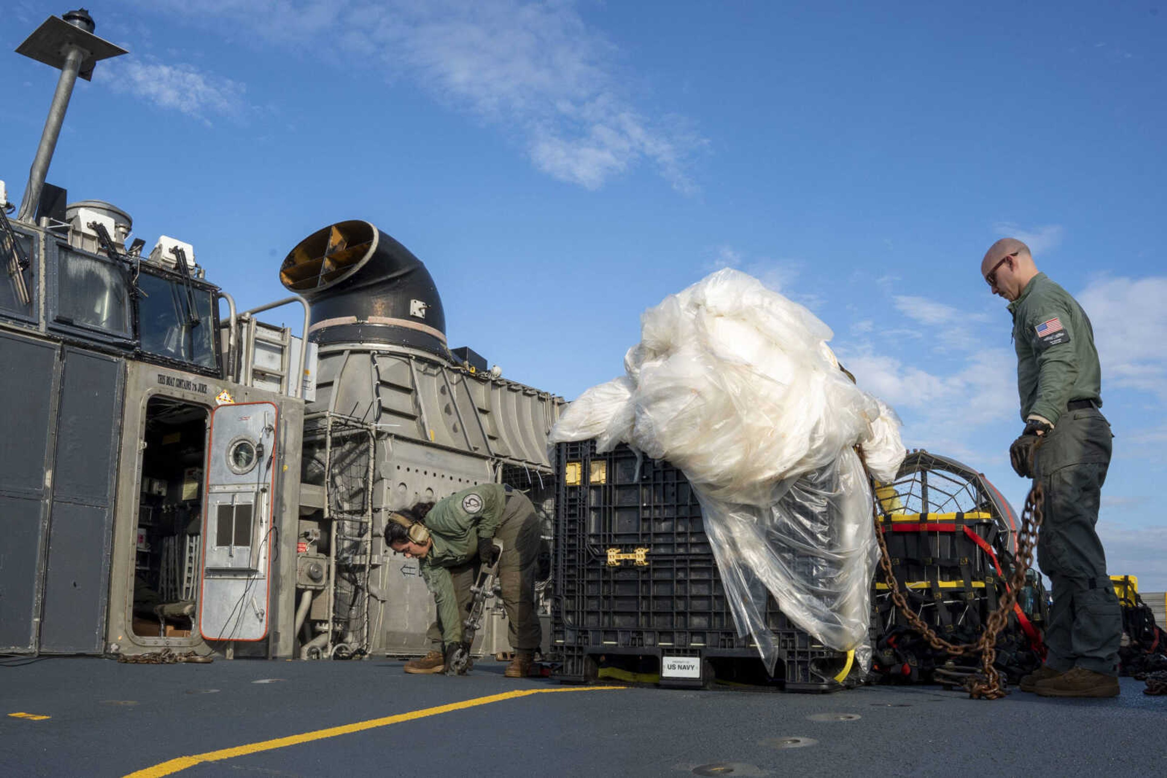 Sailors assigned to Assault Craft Unit 4 prepare material recovered off the coast of Myrtle Beach, South Carolina, in the Atlantic Ocean from the shooting down of a Chinese high-altitude balloon, for transport to the FBI, on Feb. 10 at Joint Expeditionary Base Little Creek in Virginia Beach, Virginia.