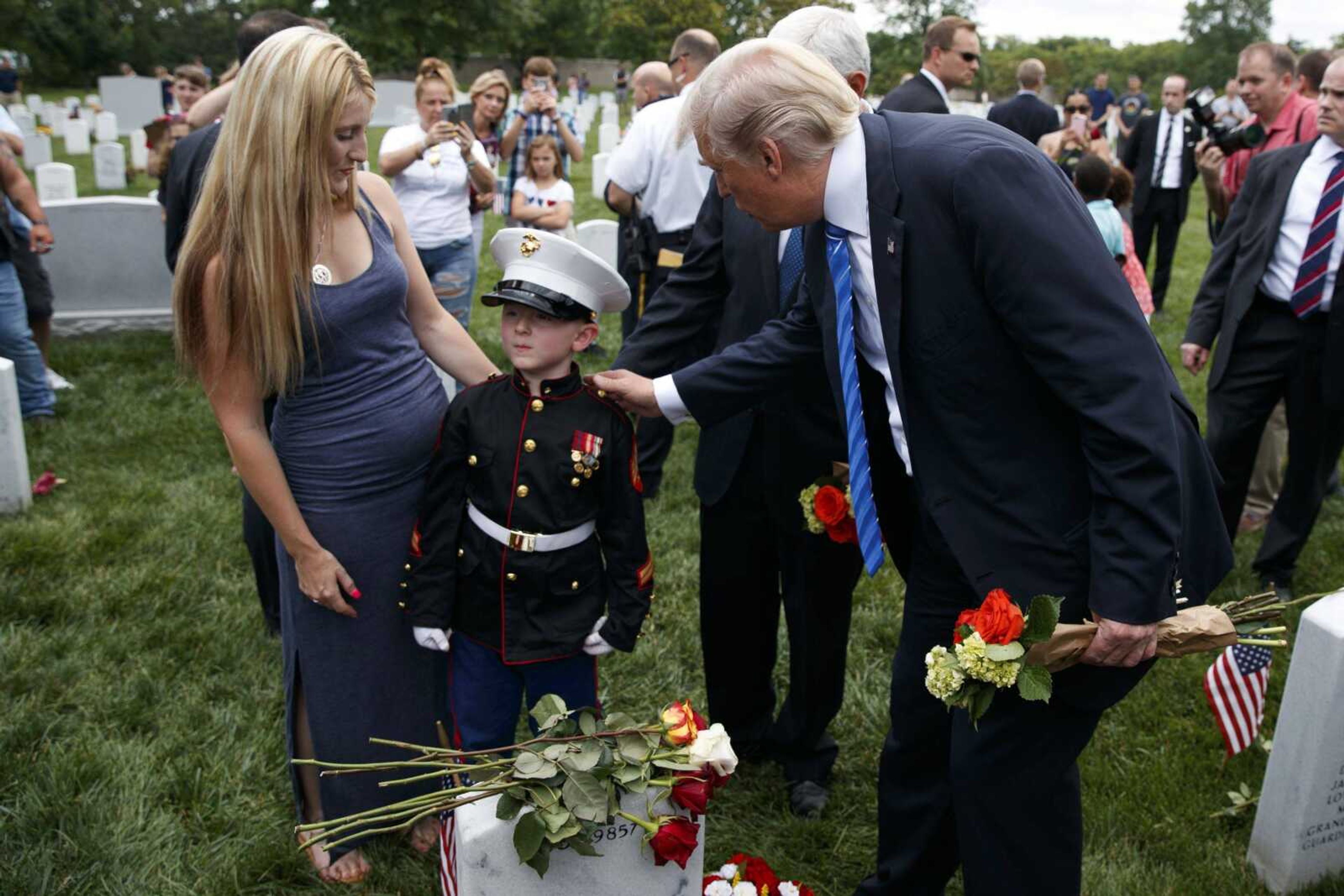 Brittany Jacobs, left, watches as her 8-year-old son, Christian Jacobs, talks with President Donald Trump on Monday in Arlington National Cemetery in Arlington, Virginia. Christian's father, Marine Sgt. Christopher Jacobs, was killed in 2011.