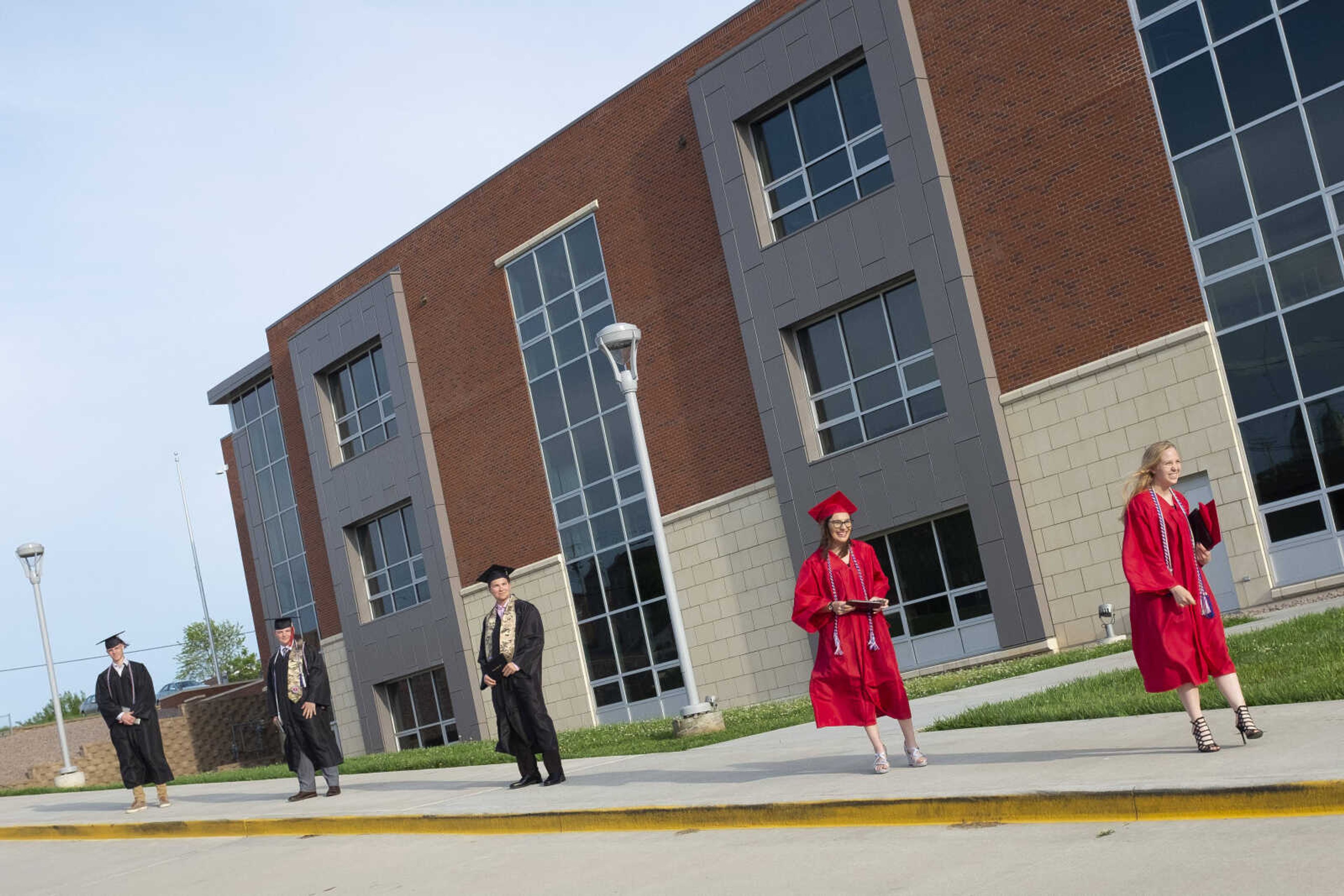 Jackson High School graduates (from right) Erin Taylor Huff, Amber Marie Lowes, Logan Wayne McClanahan, Caleb Scott Anderson and Jacob Charles Farrar stand for a parade following an in-person military graduation ceremony Friday, May 22, 2020, at Jackson High School.