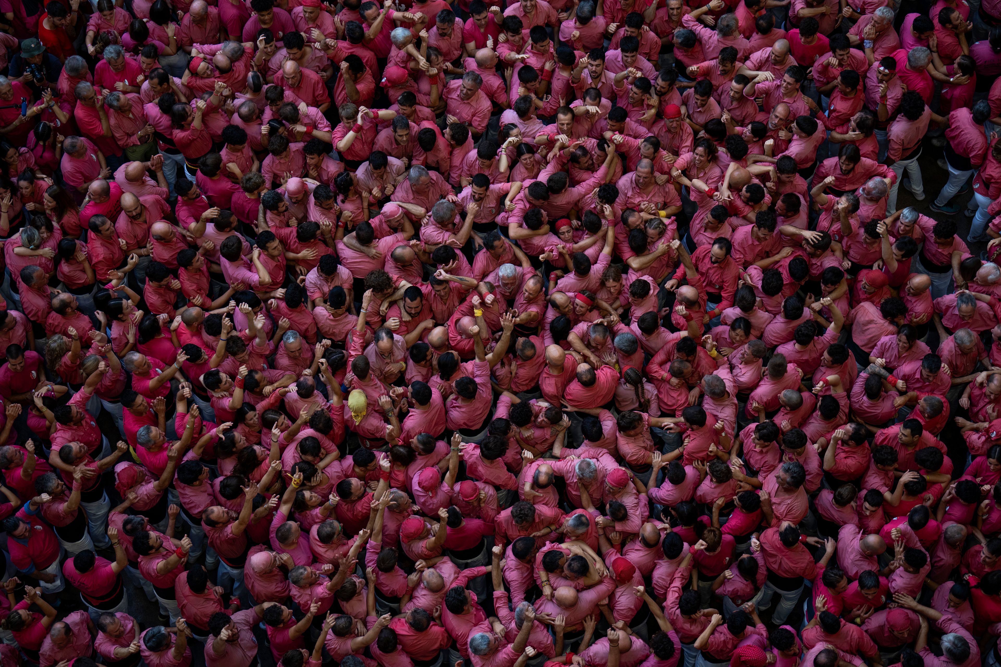 Members of "Vella de Valls" celebrate after completing a "Castell" or human tower, during the 29th Human Tower Competition in Tarragona, Spain, Sunday, Oct. 6, 2024. (AP Photo/Emilio Morenatti)