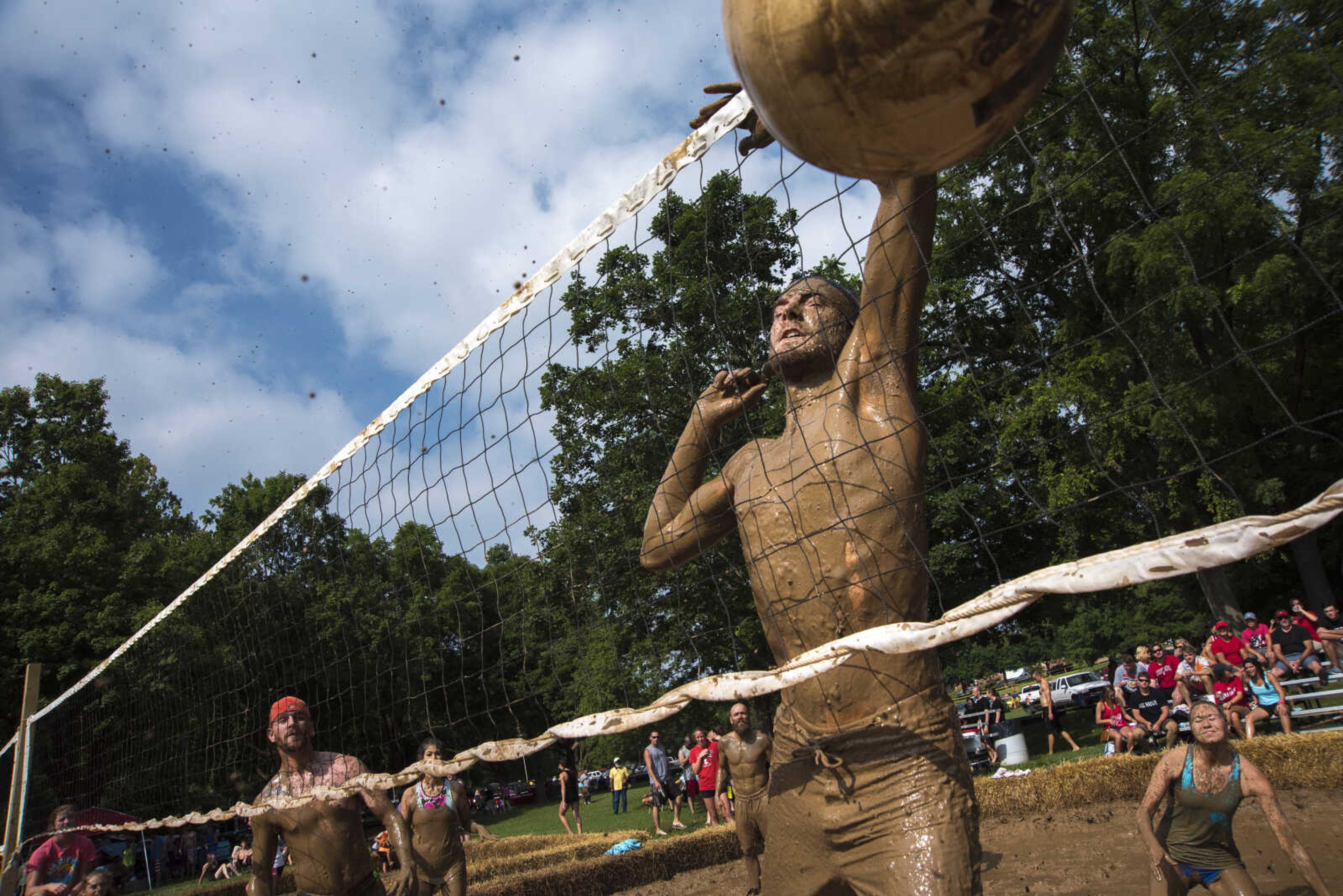 Chris Carr spikes the ball during mud volleyball for the Jackson Parks and Recreation's July 4th celebration Tuesday, July 4, 2017 in Jackson City Park.