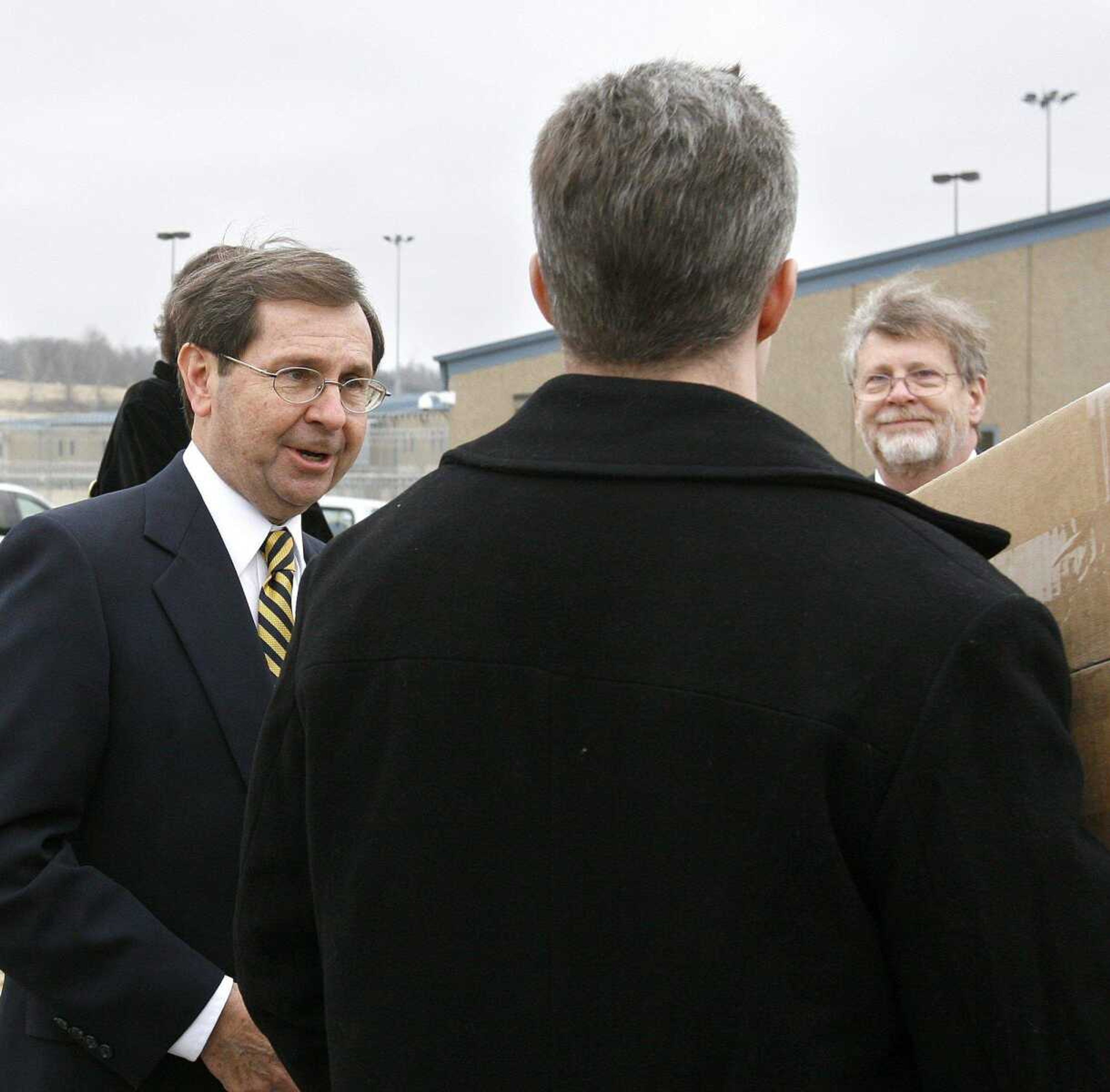 ELIZABETH DODD ~ edodd@semissourian.com
Attorneys who represented Kezer, Charles Weiss, left, and Steve Snodgrass of the Bryan Cave Law Firm say their congratulations before Kezer leaves as a free man.