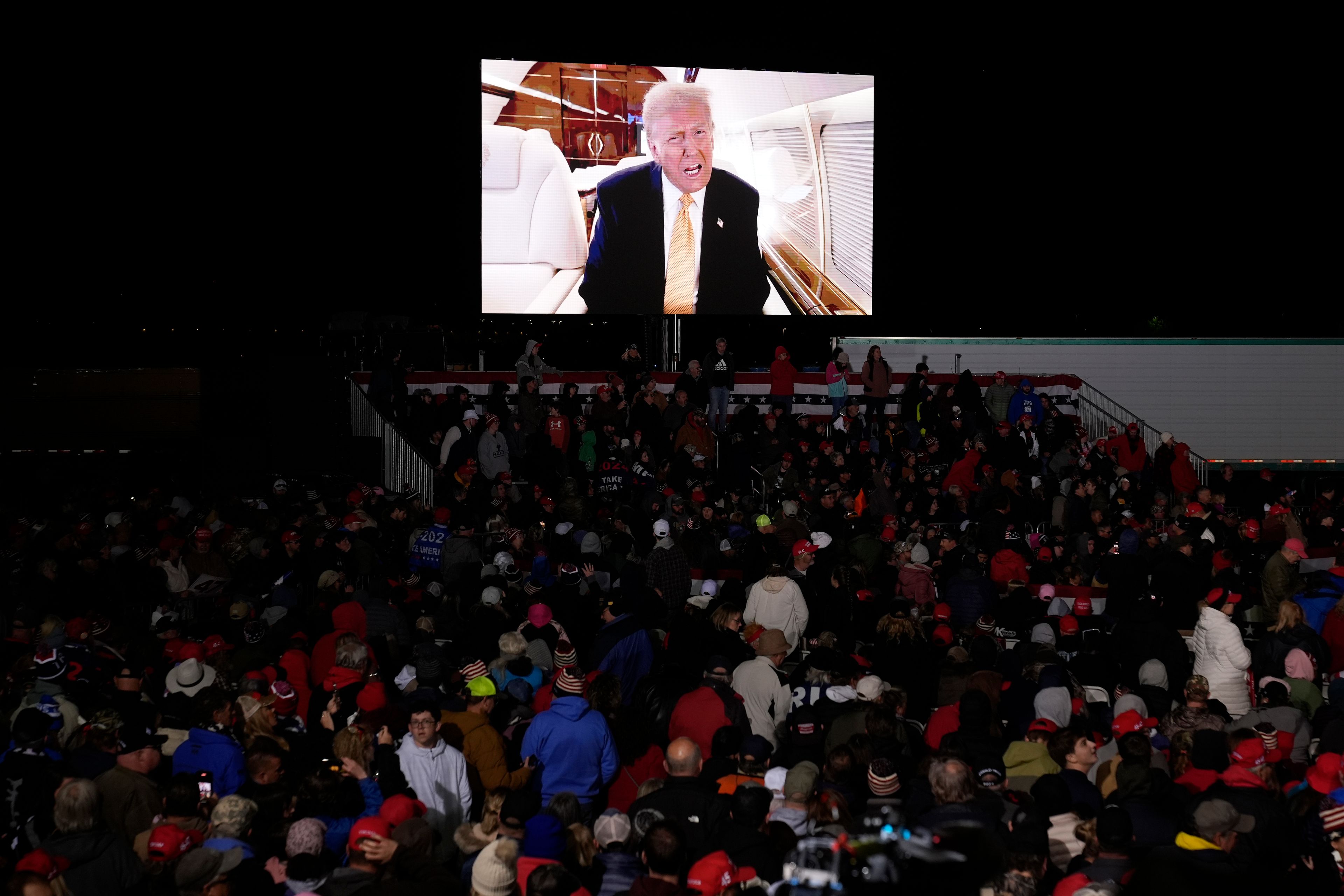 A video message from Republican presidential nominee former President Donald Trump is played at a campaign event Friday, Oct. 25, 2024, in Traverse City, Mich. (AP Photo/Paul Sancya)