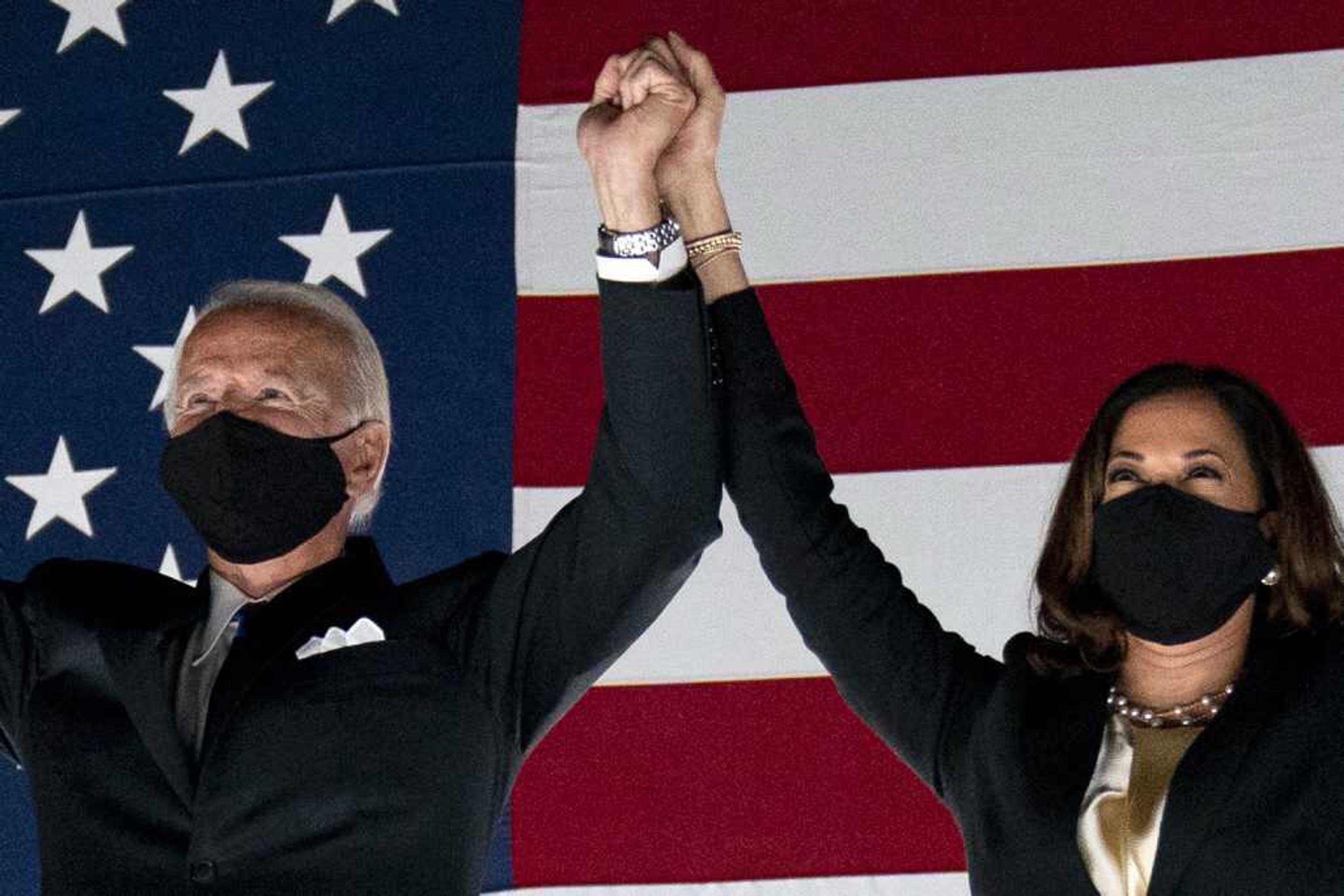 Democratic presidential candidate former Vice President Joe Biden and his running mate Sen. Kamala Harris watch fireworks during the fourth day of the Democratic National Convention at the Chase Center in Wilmington, Delaware.