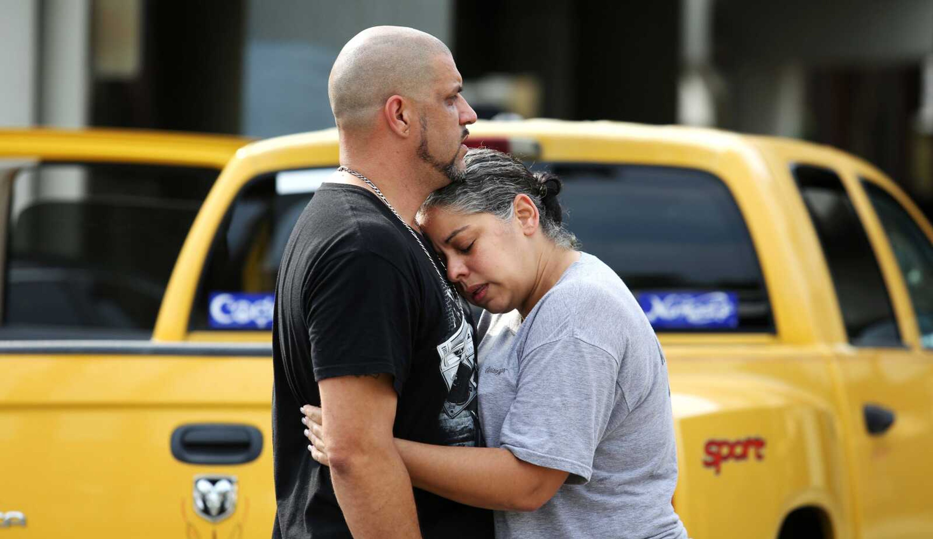 Ray Rivera, a DJ at Pulse Orlando nightclub, is consoled by a friend outside of the Orlando Police Department after a shooting involving dozens of fatalities at the nightclub Sunday. (