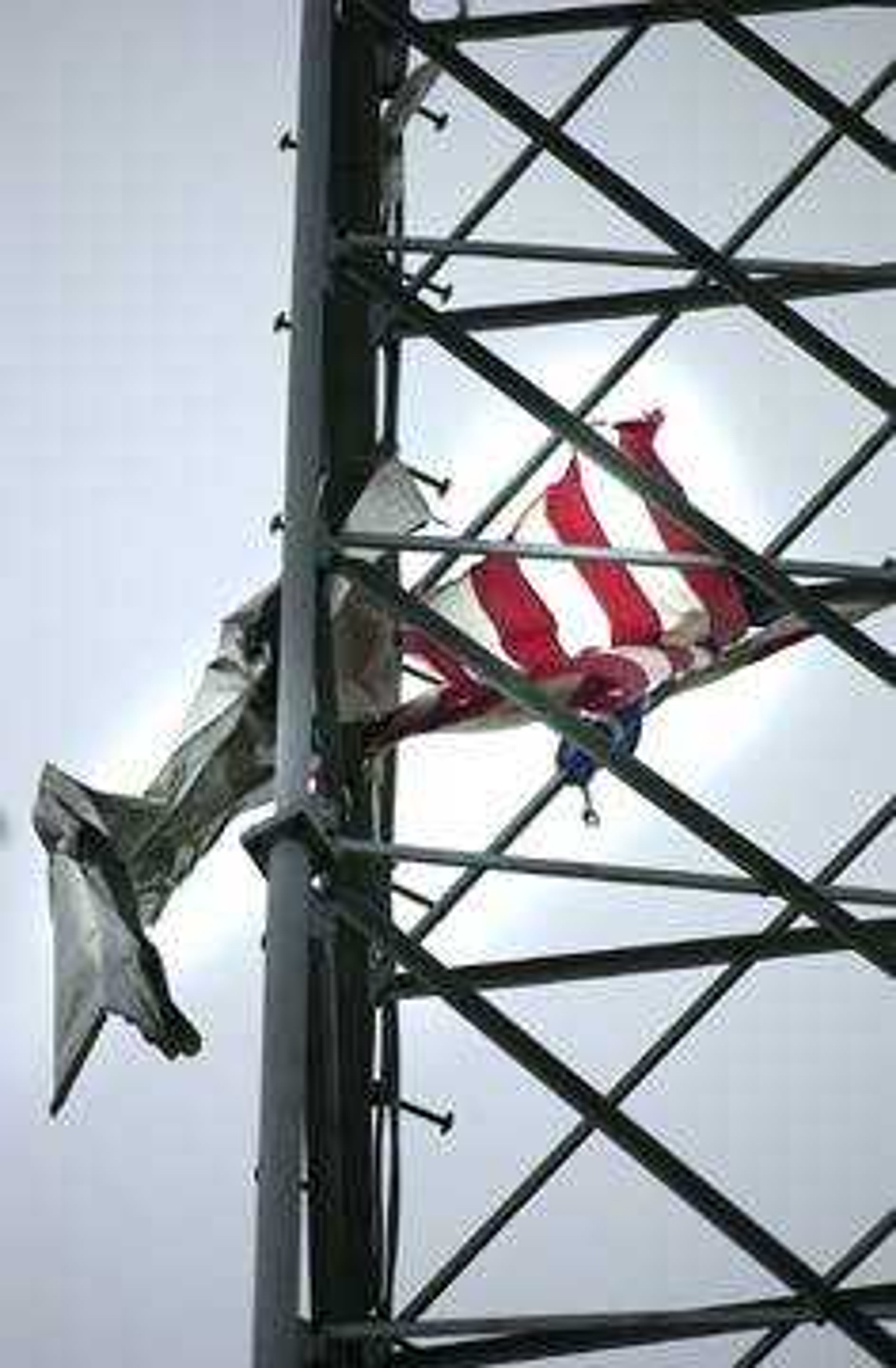 An American flag was thrown high above the police and fire stations, and got caught in the large antenna.