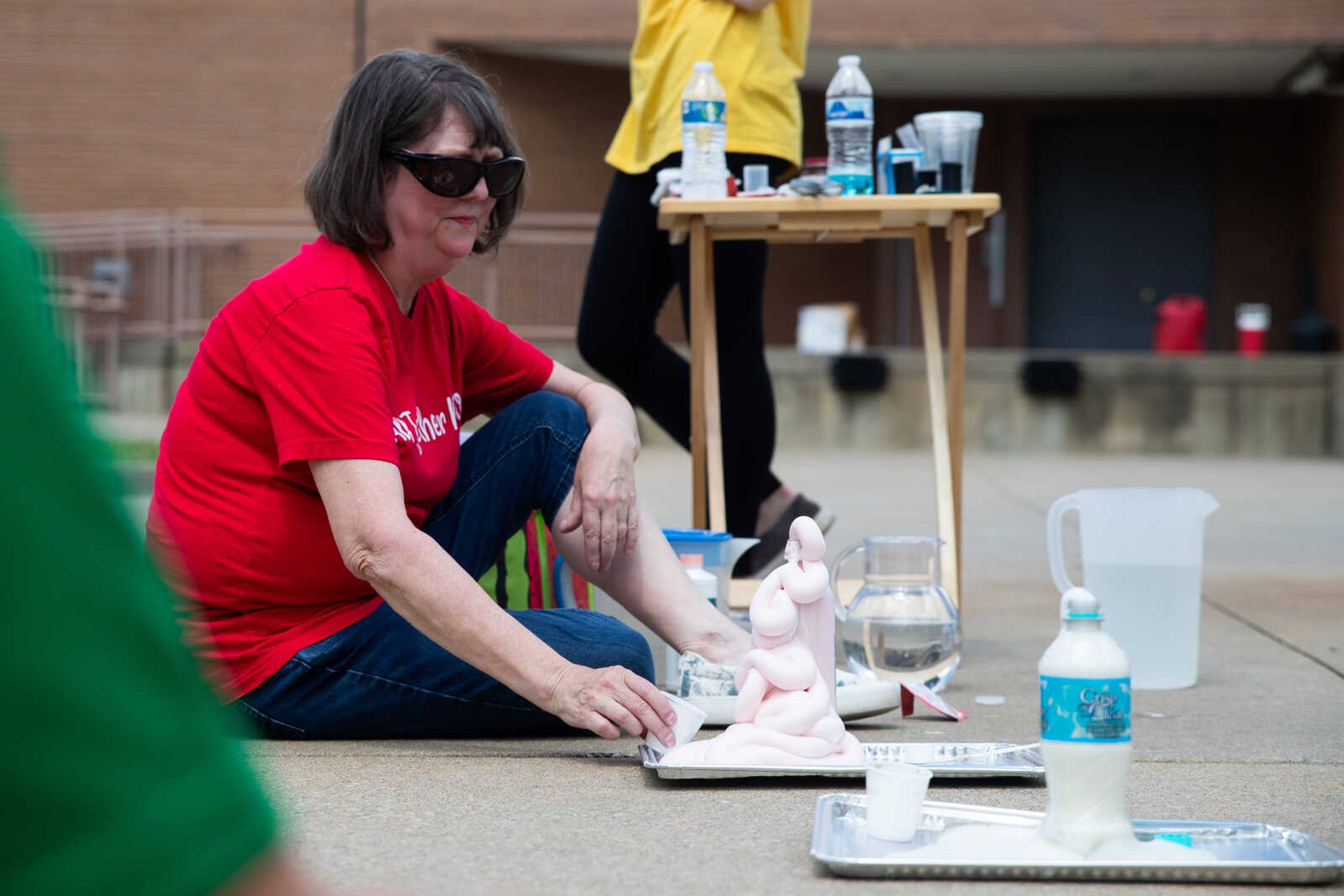 Teacher Becky Hicks demonstrates an experiment.