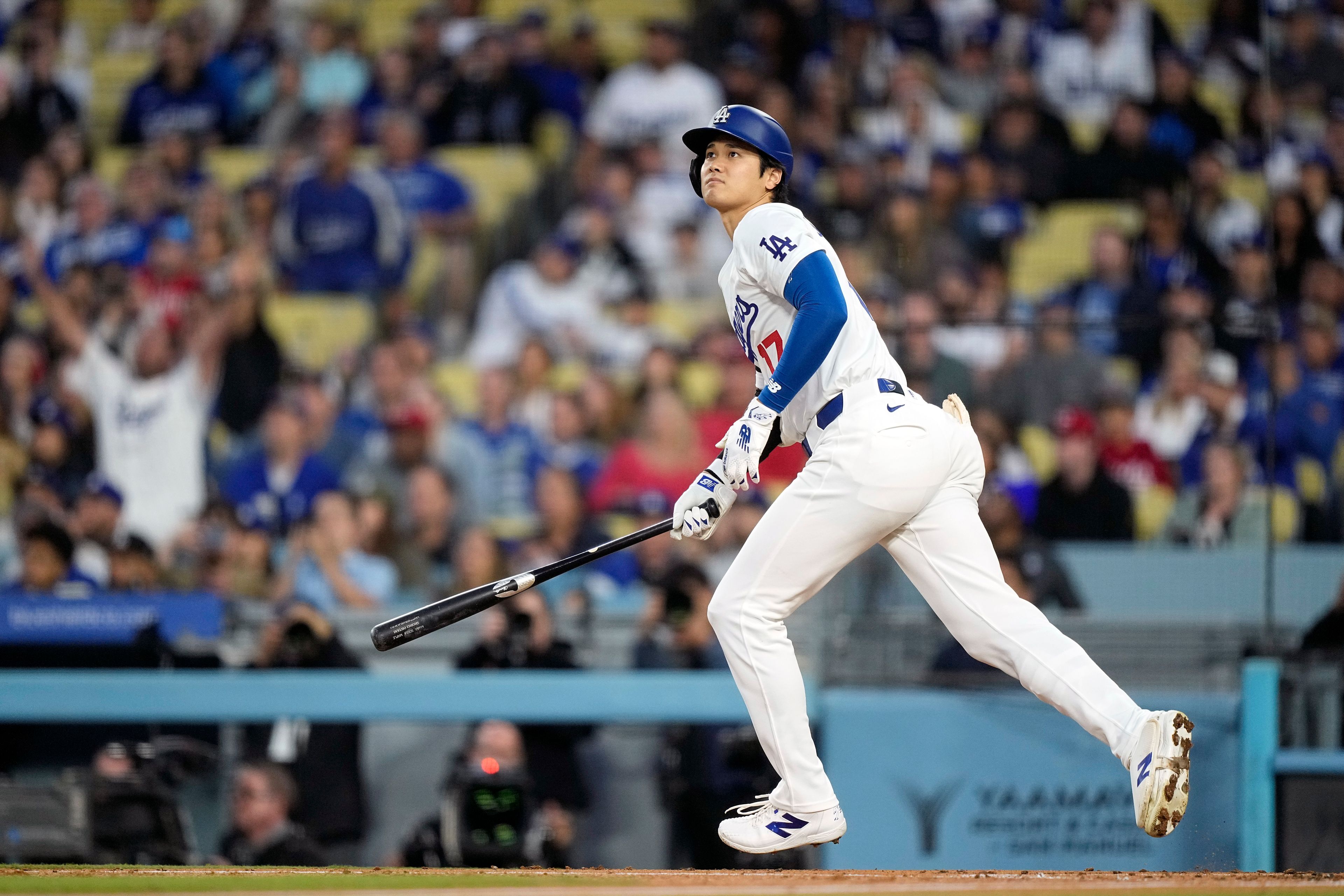 Los Angeles Dodgers designated hitter Shohei Ohtani heads to first after hitting a two-run home run during the third inning of a baseball game against the Cincinnati Reds Friday, May 17, 2024, in Los Angeles. (AP Photo/Mark J. Terrill)