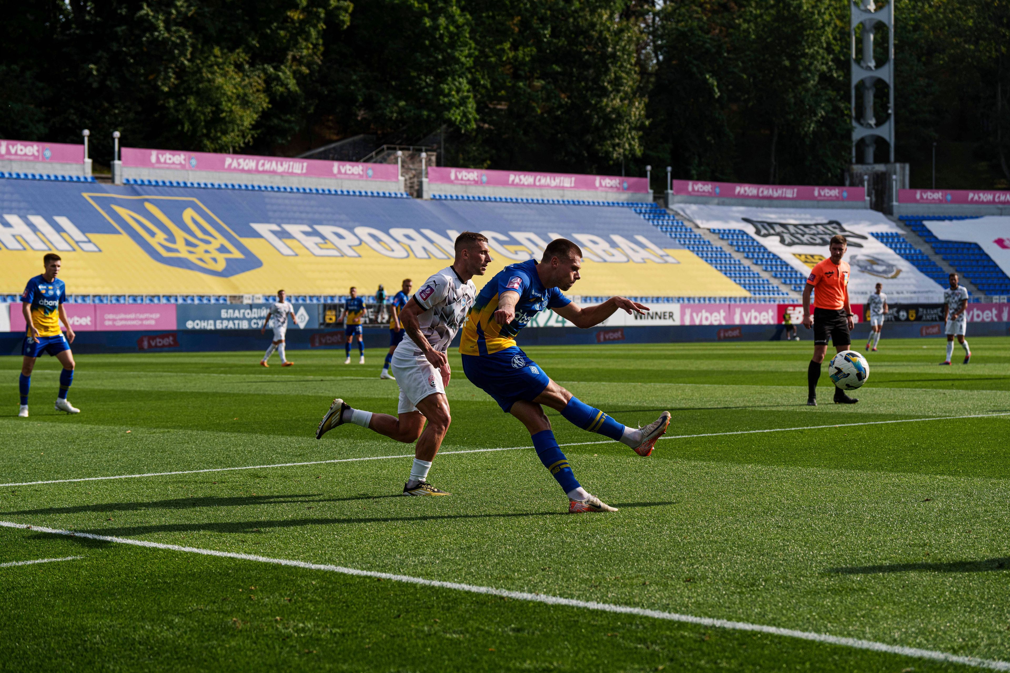 Mykola Mykhailenko of Dynamo Kyiv, clears the ball as Ihor Kiriukhantsev of Zorya Luhansk closes in during a soccer match of Ukrainian Premier League in Kyiv, Ukraine, Saturday Sept. 14, 2024. (AP Photo/Evgeniy Maloletka)