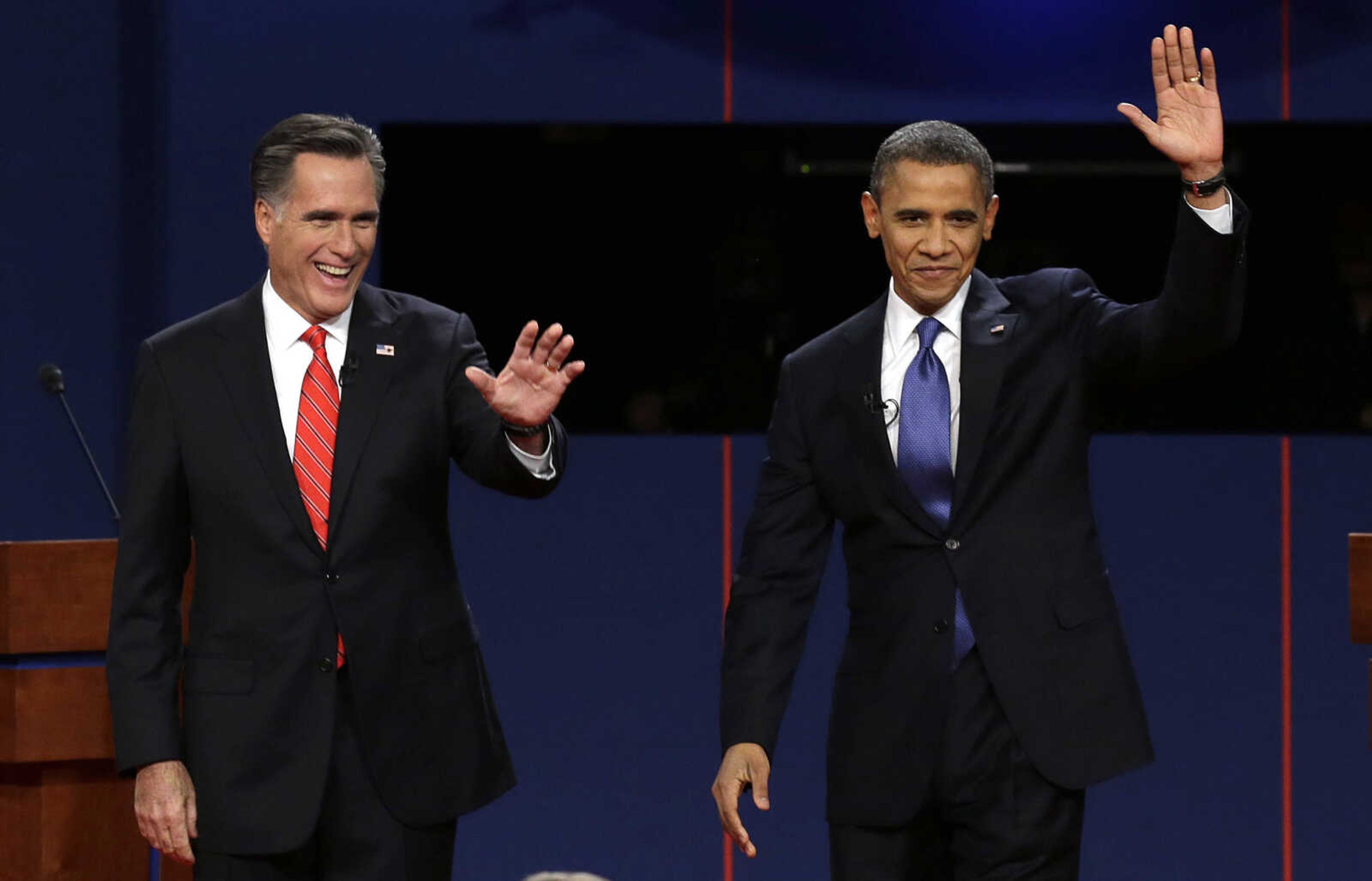 FILE - In this Oct. 3, 2012, file photo, Republican presidential candidate Mitt Romney and President Barack Obama wave to the audience during the first presidential debate at the University of Denver in Denver. The sixth "town hall" style presidential debate will bring Obama and Romney to Hofstra University on New York's Long Island Tuesday, Oct. 16, 2012. They'll take questions from undecided voters selected by Gallup. (AP Photo/Charlie Neibergall, File)