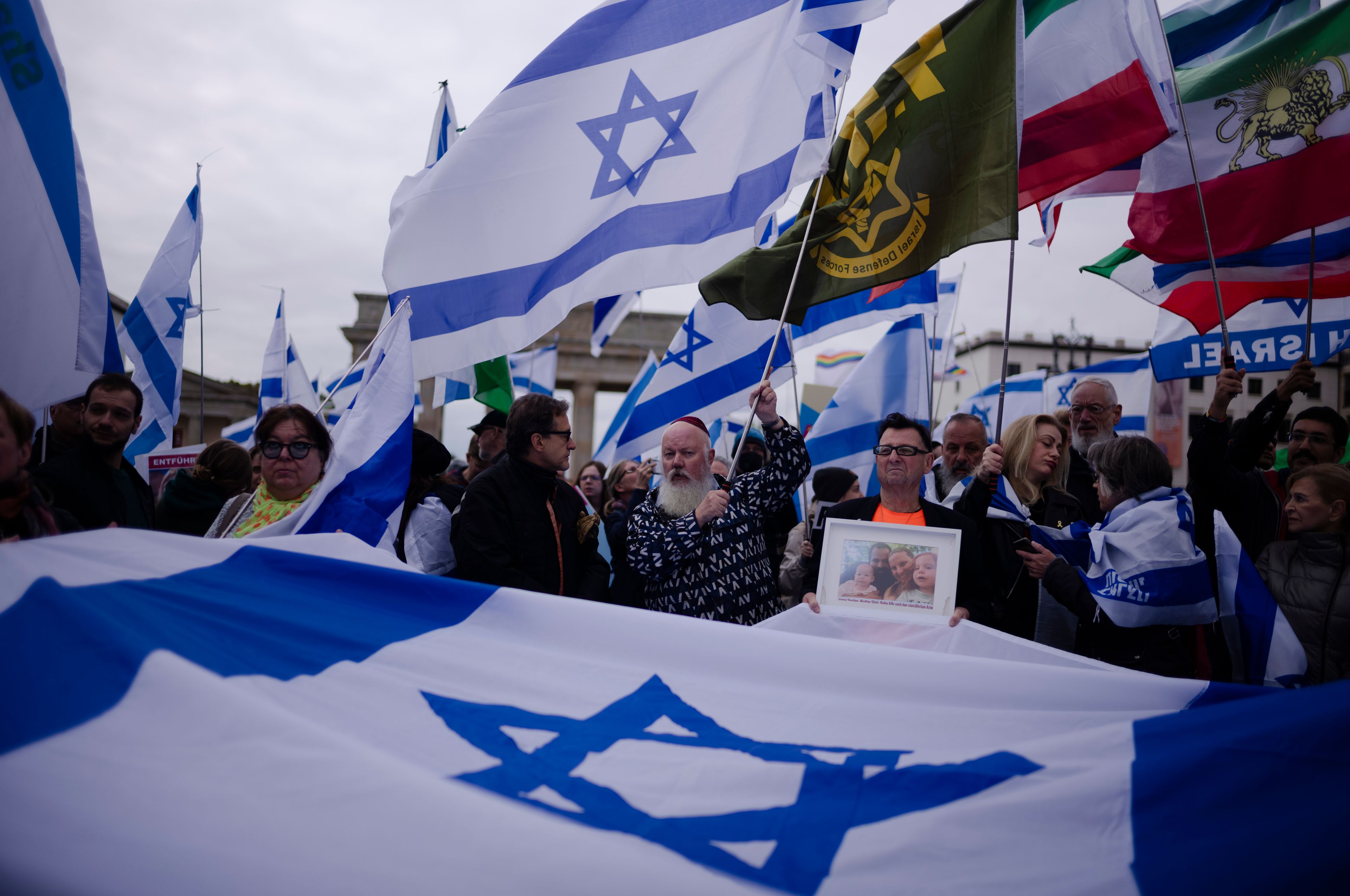 People attend a demonstration in support of Israel to mark the first anniversary of the Hamas attack on Israel, at the Brandenburg Gate in Berlin, Germany, Sunday, Oct. 6, 2024. (AP Photo/Markus Schreiber)