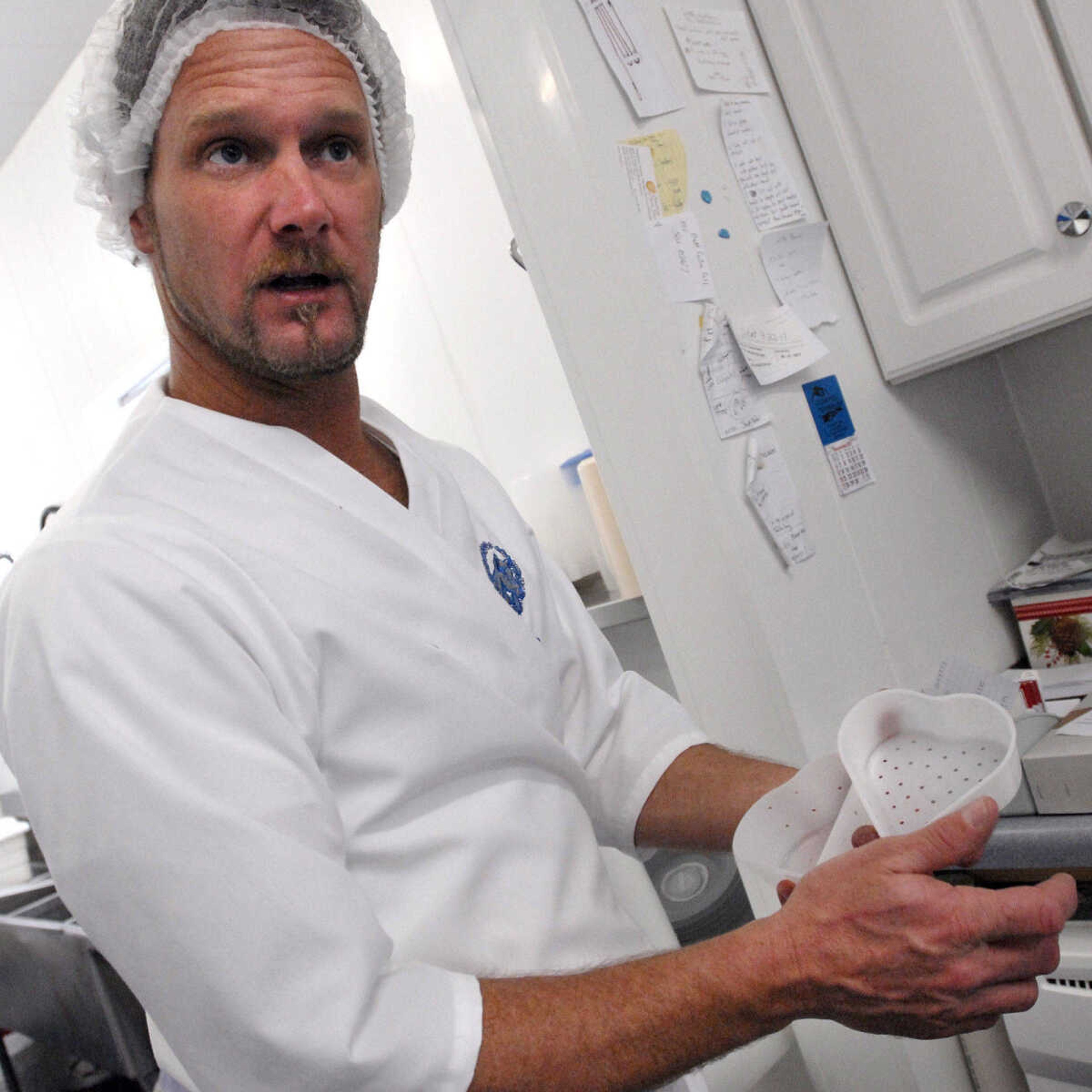 LAURA SIMON ~ lsimon@semissourian.com
Steve Baetje shows one of the heart shaped molds used to make Coeur de la Creme, pure artisan goat cheese Wednesday, Dec. 14, 2011 at Baetje Farms in Bloomsdale, Mo.