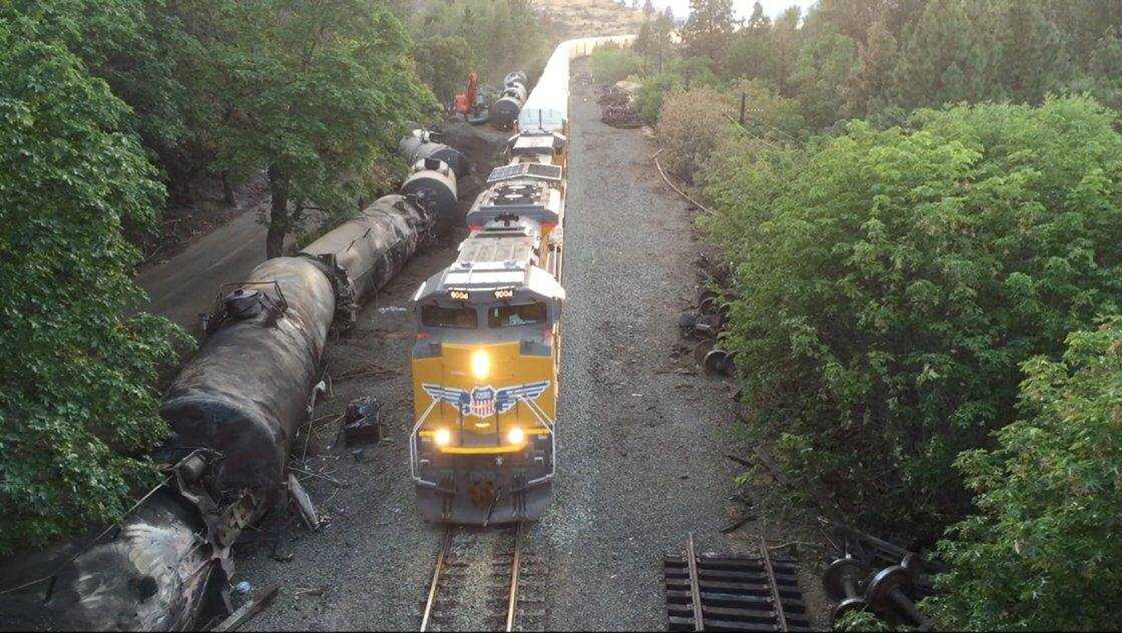 This June 6 aerial video image taken from a drone shows crumpled oil tankers lying beside the railroad tracks after a fiery June 3 train derailment that prompted evacuations from the tiny Columbia River Gorge town of Mosier, Oregon.