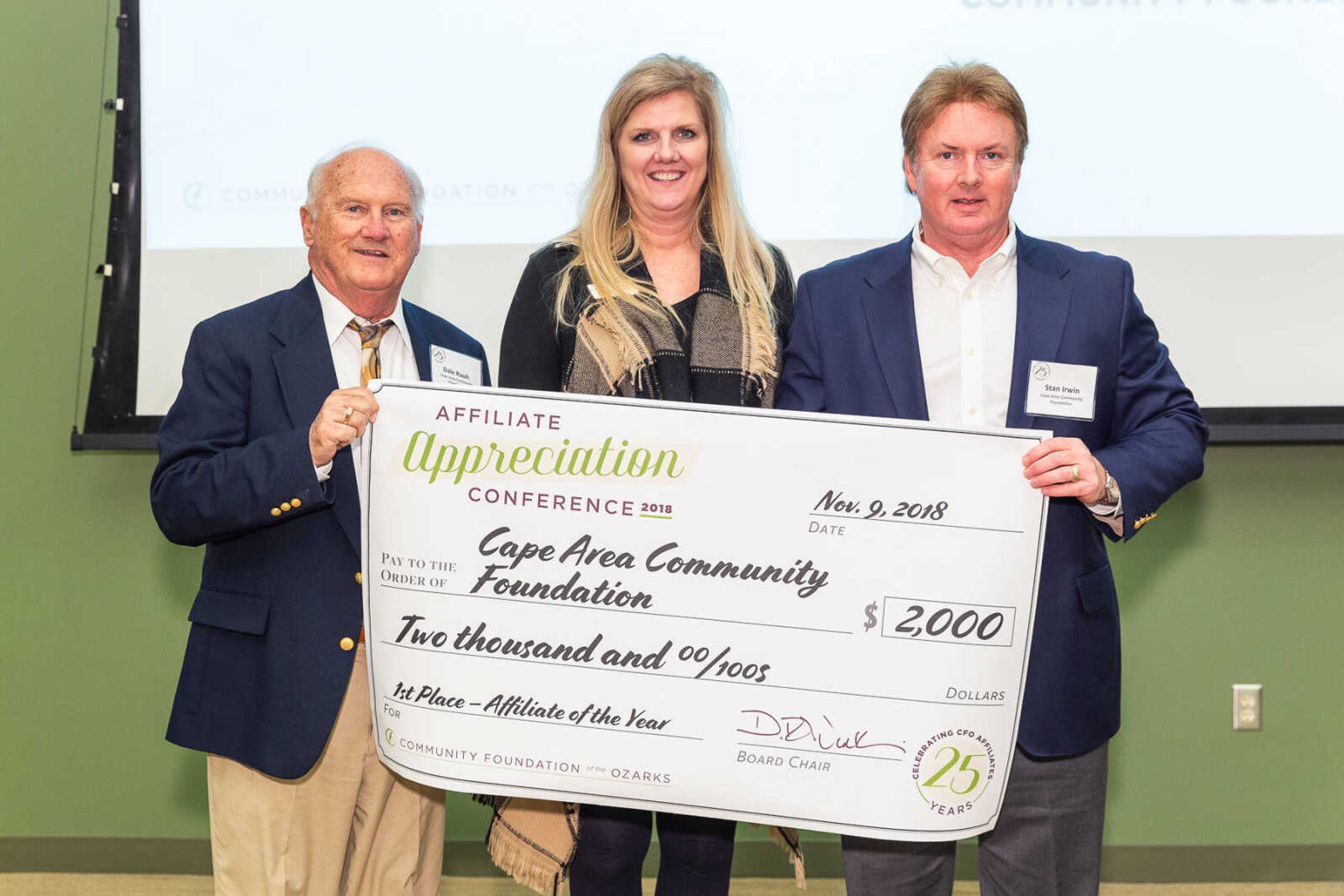 Judy Cantoni, center, presents the Affiliate of the Year award to CACF board leaders Dale Rauh, left, and Stan Irwin. 
