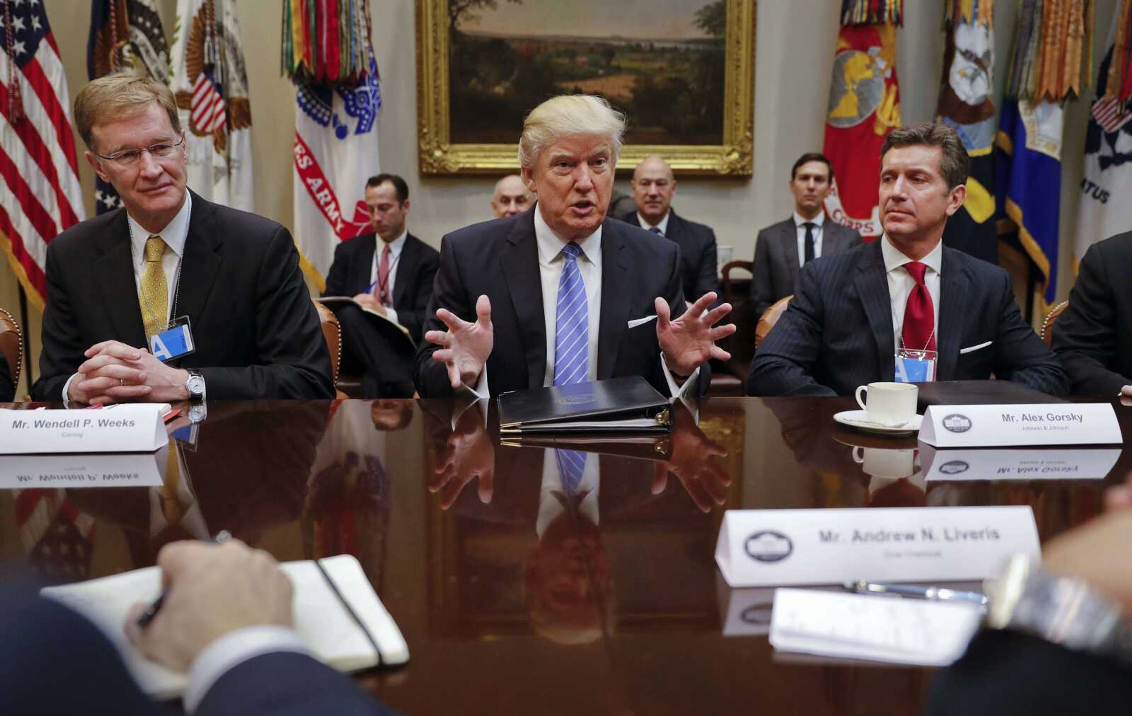 President Donald Trump speaks while hosting a breakfast Monday with business leaders in the Roosevelt Room of the White House in Washington. At left is Wendell P. Weeks, CEO of Corning; at right is Alex Gorsky, chairman and CEO of Johnson & Johnson.