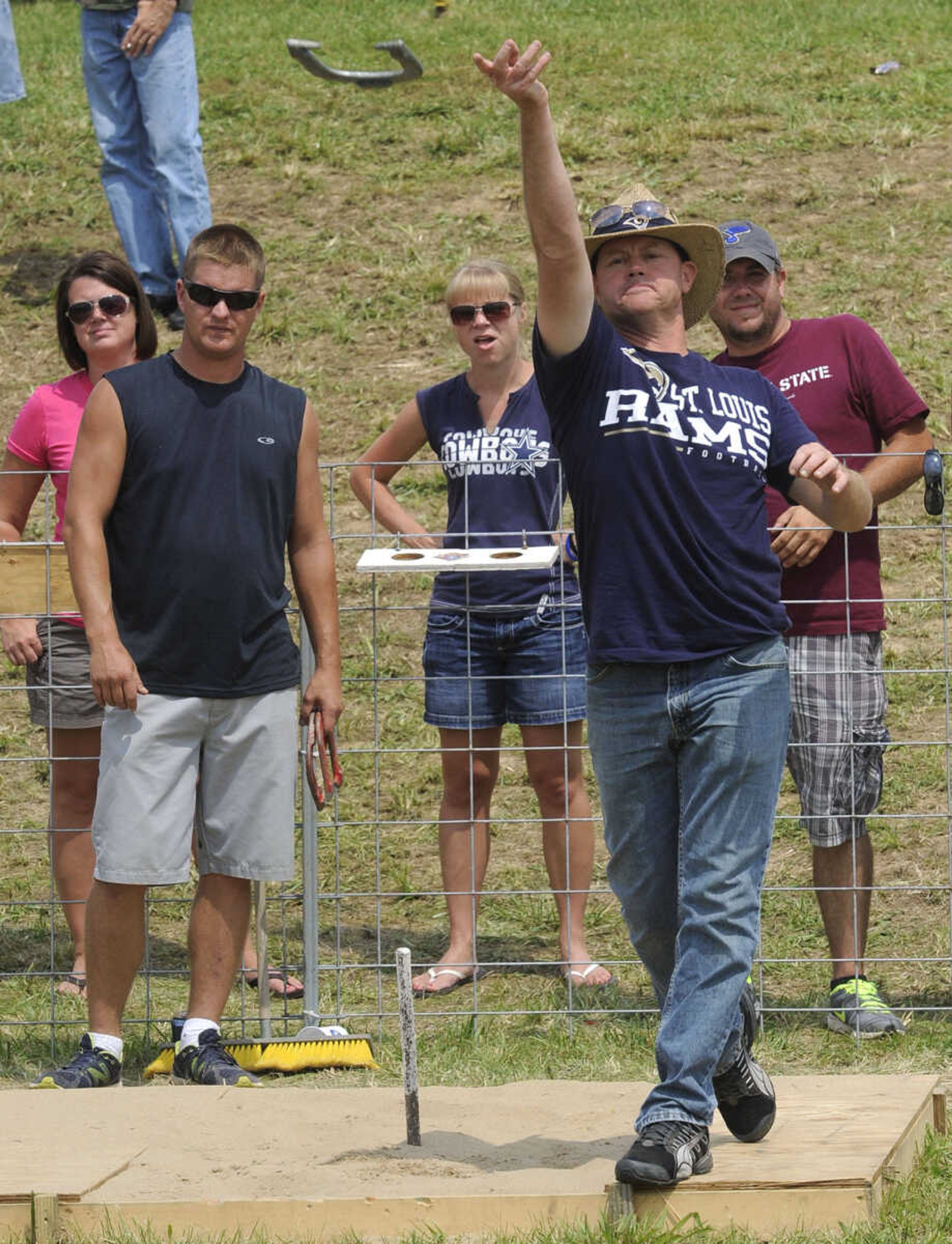 Glenn Rollhaus pitches a horseshoe as Blake Stomberg watches. Both are of Ste. Genevieve, Mo.