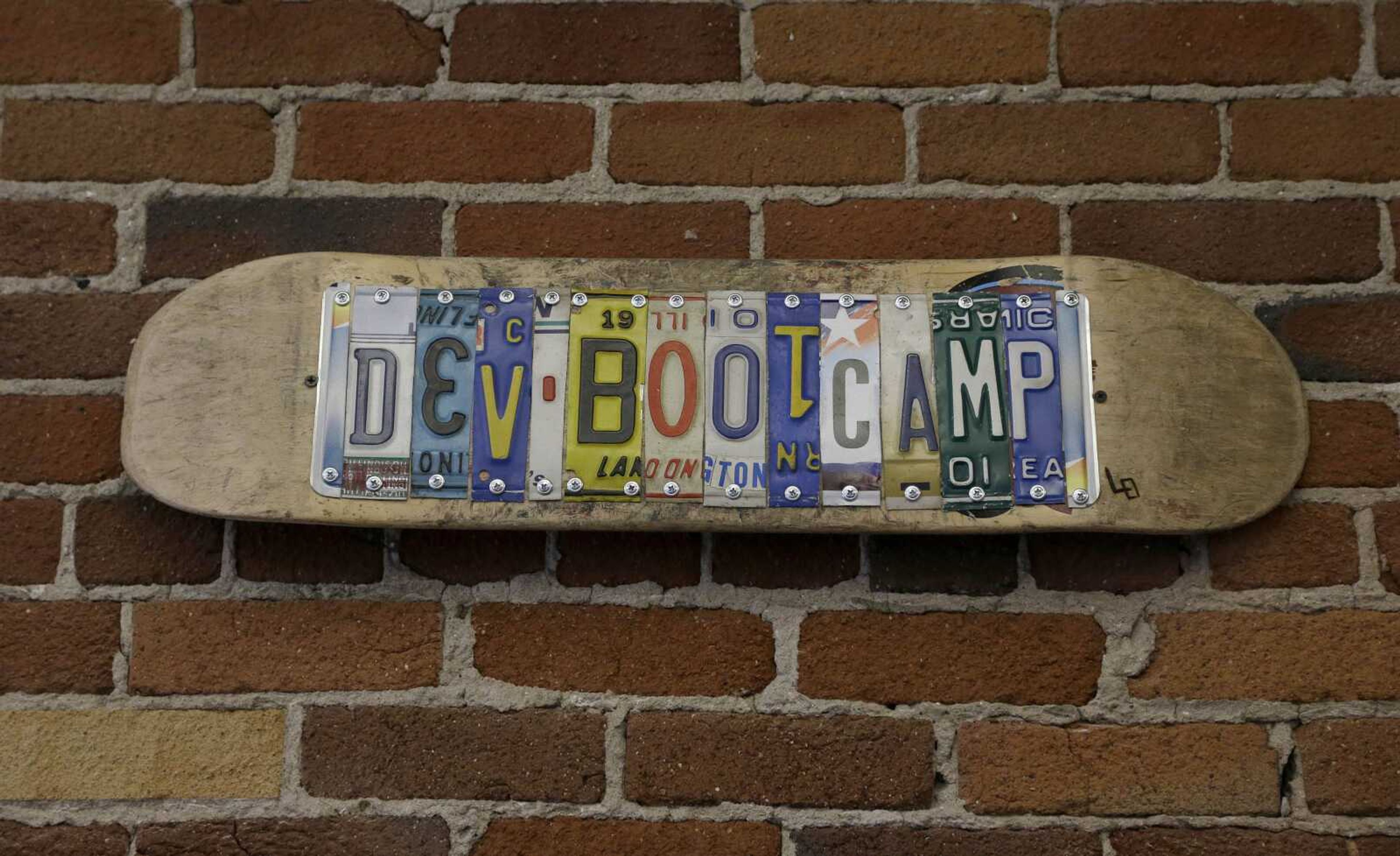 A sign for Dev Bootcamp is shown at their office in San Francisco, Tuesday, April 2, 2013. Dev Bootcamp is one of a new breed of computer-programming schools that&#237;s proliferating in San Francisco and other U.S. tech hubs. These &#236;hacker boot camps&#238; promise to teach students how to write code in two or three months and help them get hired as web developers, with starting salaries between $80,000 and $100,000, often within days or weeks of graduation. (AP Photo/Jeff Chiu)