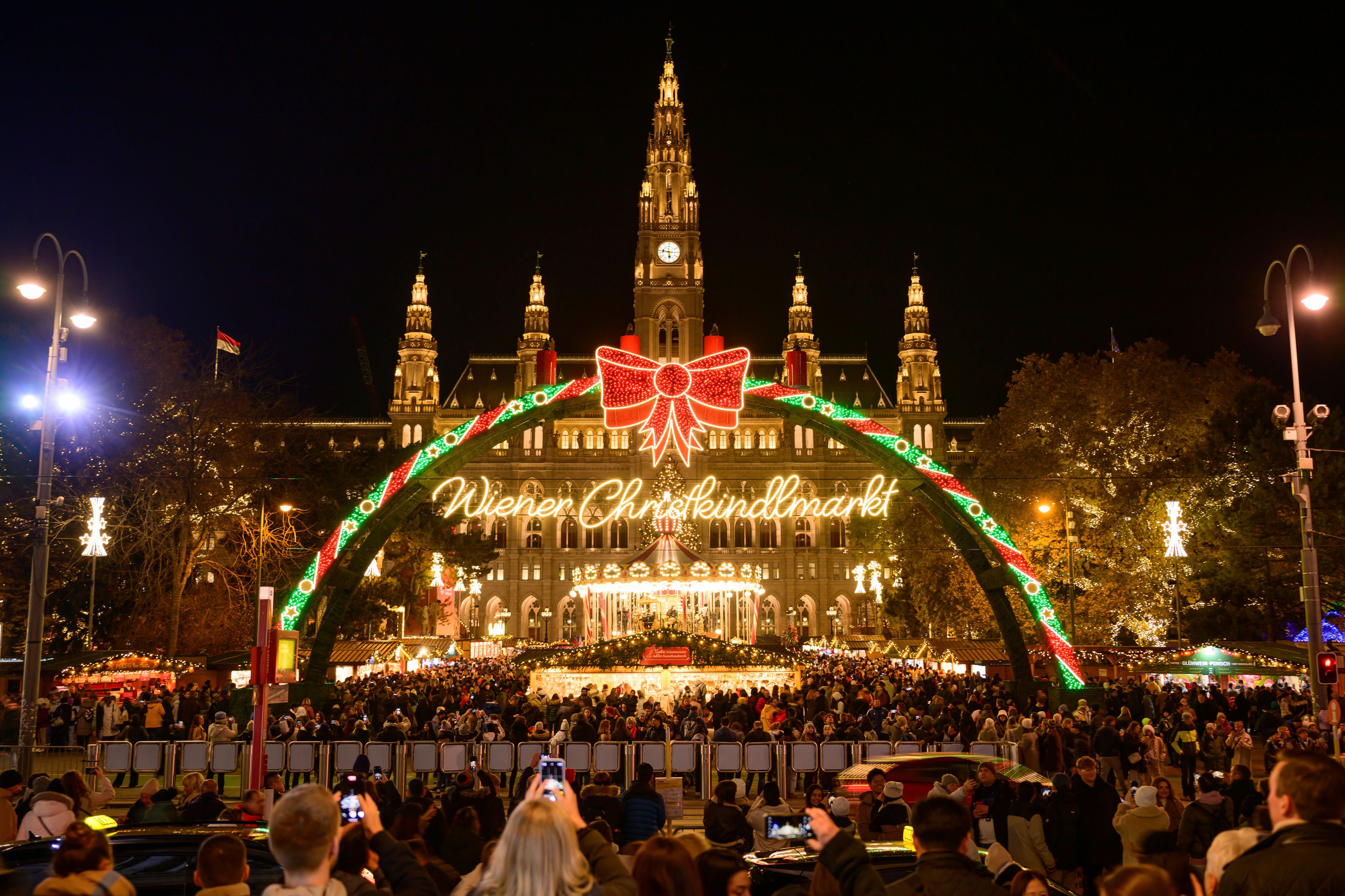 People look at the illuminations at the Wiener Chritkindlmarkt in front of Vienna's city hall, one of Vienna's most popular Christmas markets, in Vienna, Austria, Saturday, Nov. 16, 2024. (AP Photo/Christian Bruna)