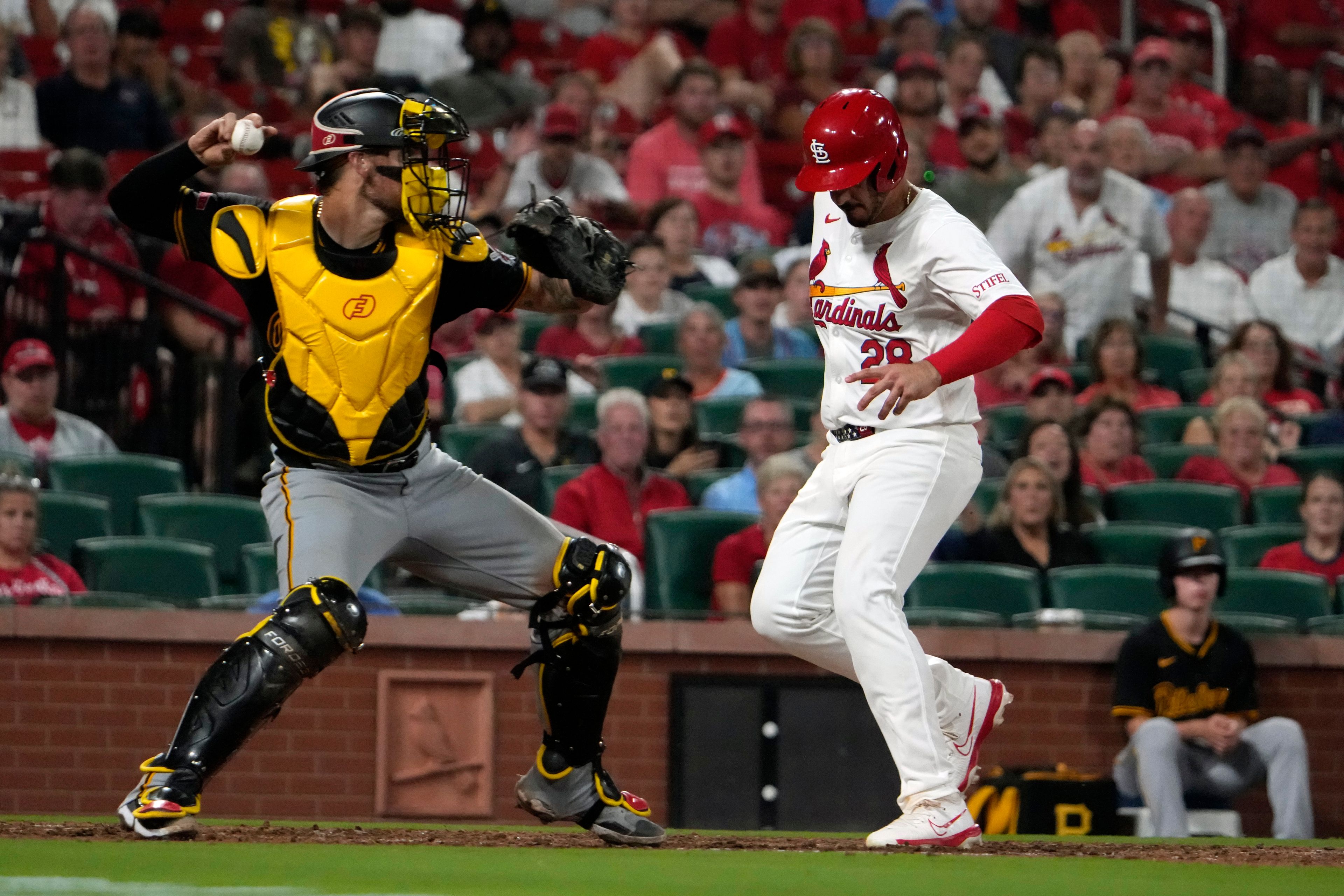 St. Louis Cardinals' Nolan Arenado, right, scores past Pittsburgh Pirates catcher Yasmani Grandal during the eighth inning of a baseball game Monday, Sept. 16, 2024, in St. Louis. (AP Photo/Jeff Roberson)