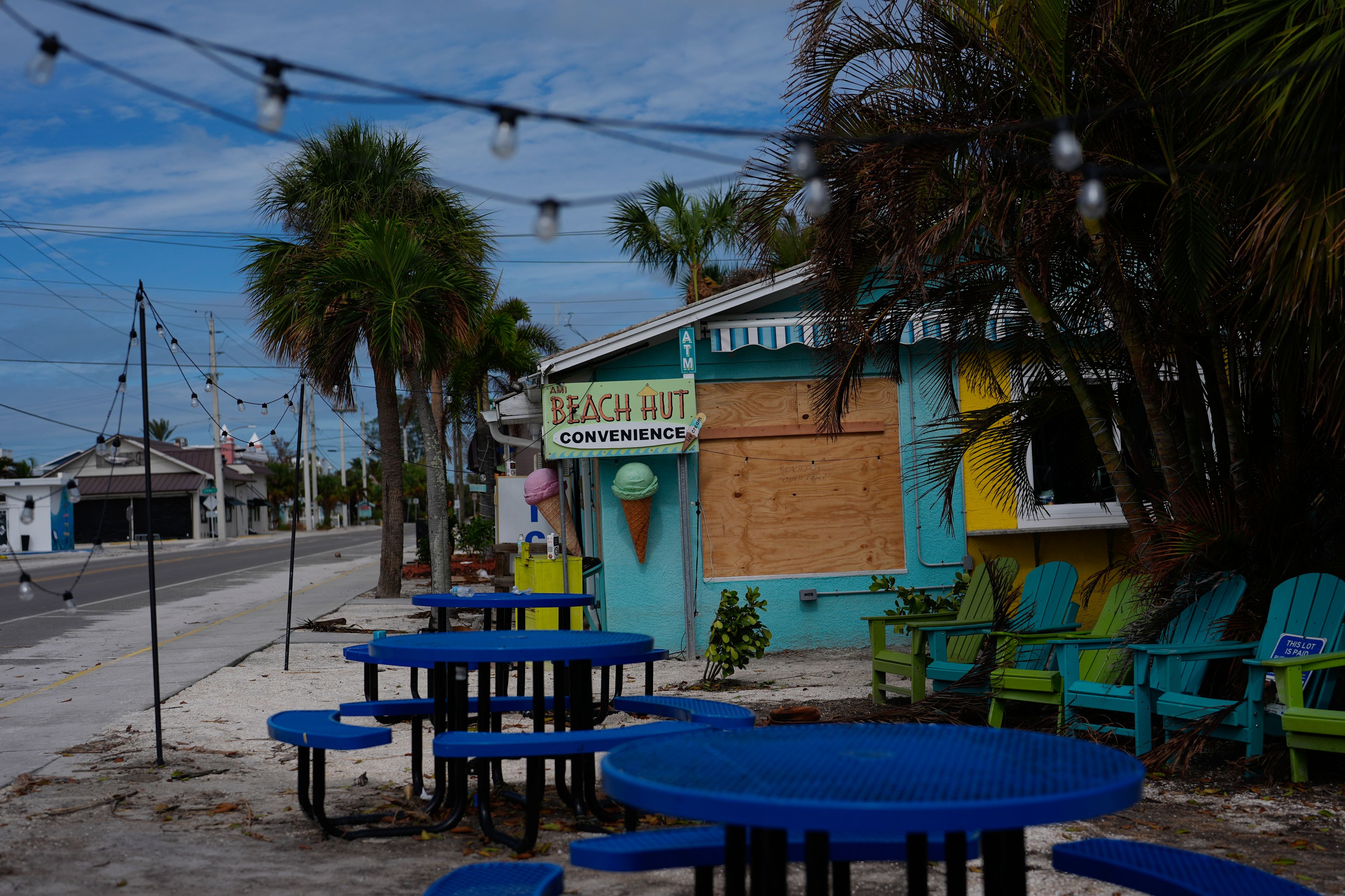 A boarded up business stands beside a deserted street in an evacuation zone, ahead of the arrival of Hurricane Milton, in Anna Maria, Fla., on Anna Maria Island, Tuesday, Oct. 8, 2024. (AP Photo/Rebecca Blackwell)