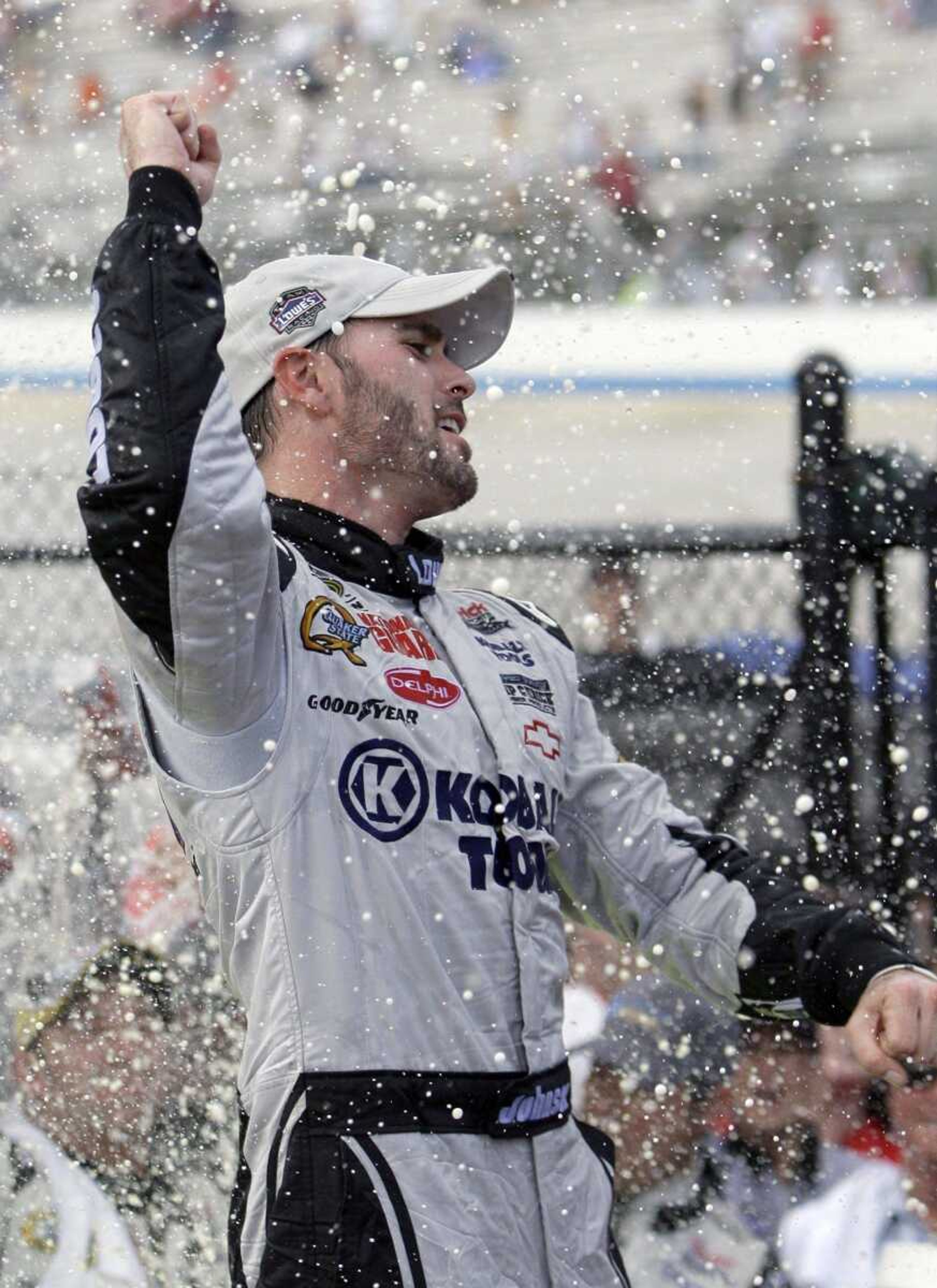 Jimmie Johnson celebrates in victory lane after Sunday's win in Dover, Del. (ROB CARR ~ Associated Press)