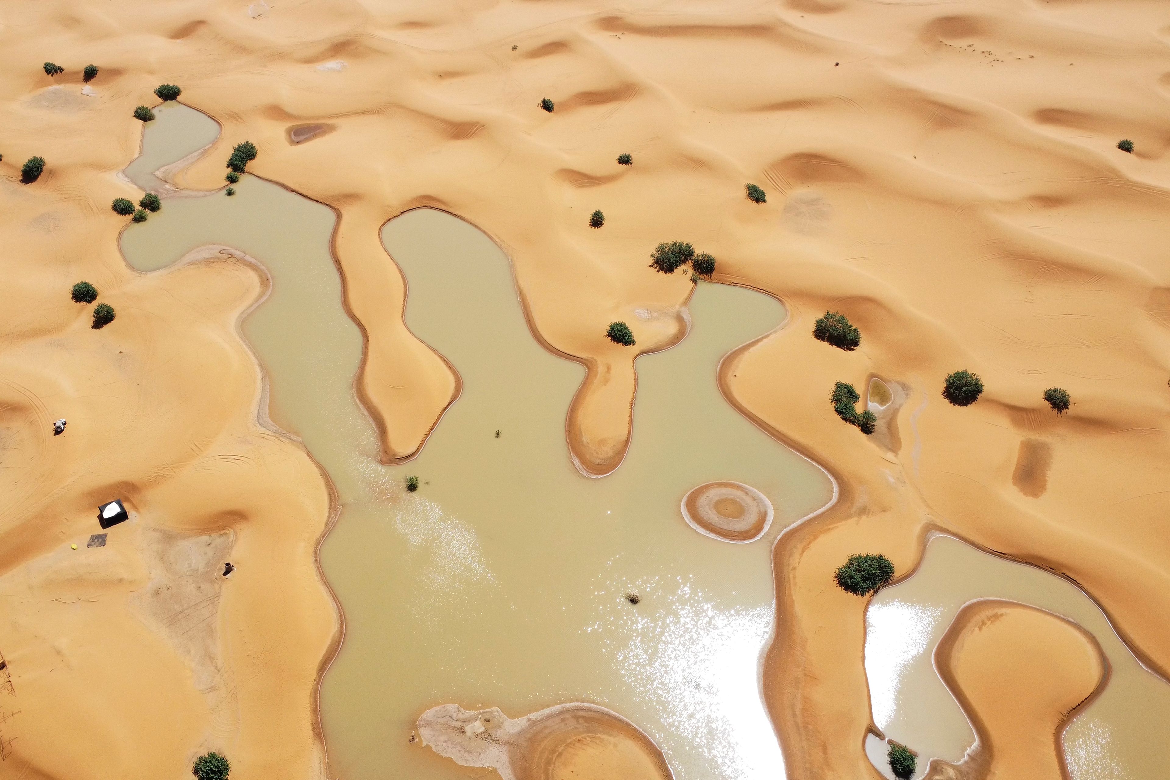 A view of lakes caused by heavy rainfall between sand dunes in the desert town of Merzouga, near Rachidia, southeastern Morocco, Wednesday, Oct. 2, 2024. (AP Photo)