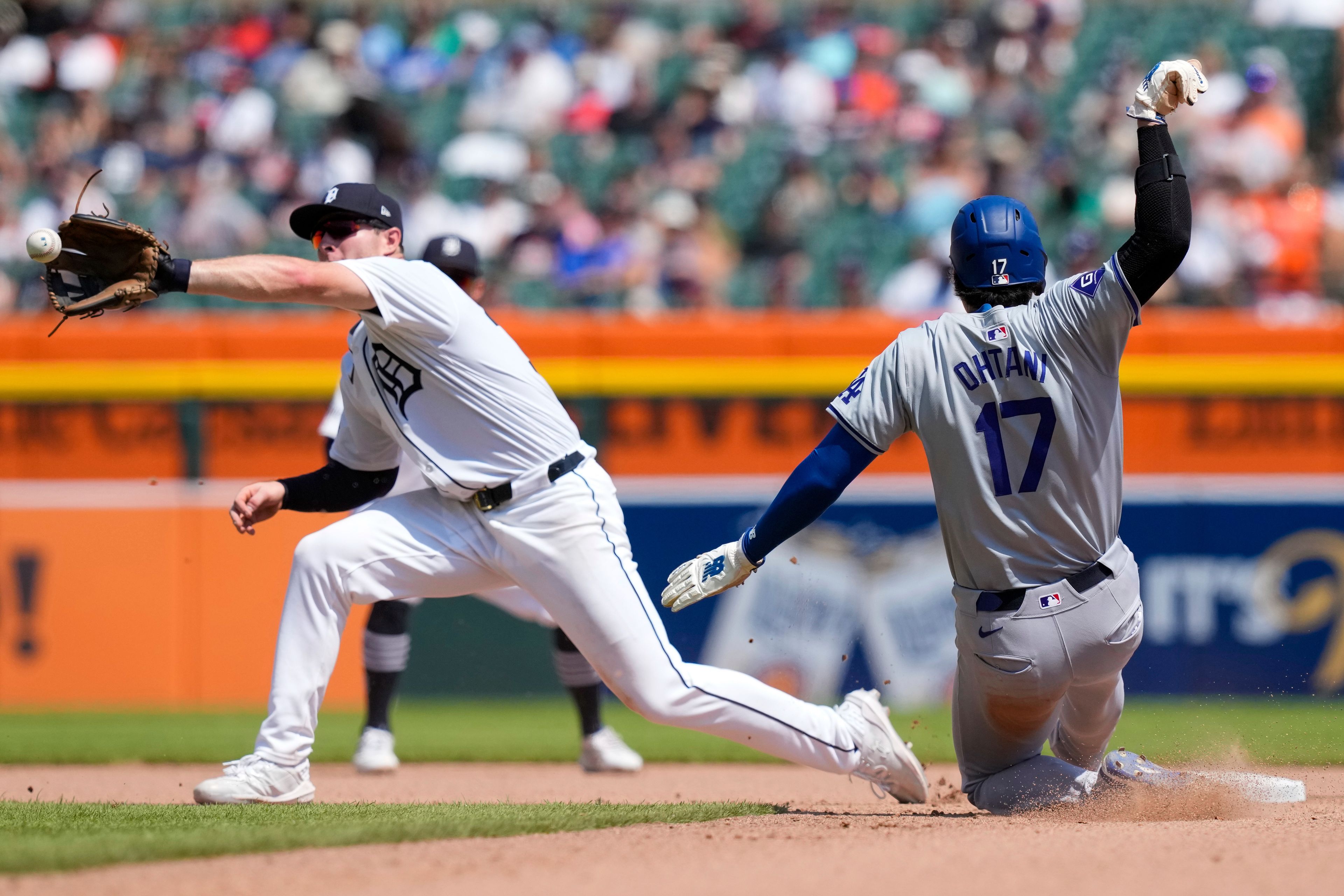 Los Angeles Dodgers designated hitter Shohei Ohtani safely beats the throw to Detroit Tigers second baseman Colt Keith to steal second during the eighth inning of a baseball game, Saturday, July 13, 2024, in Detroit. (AP Photo/Carlos Osorio)