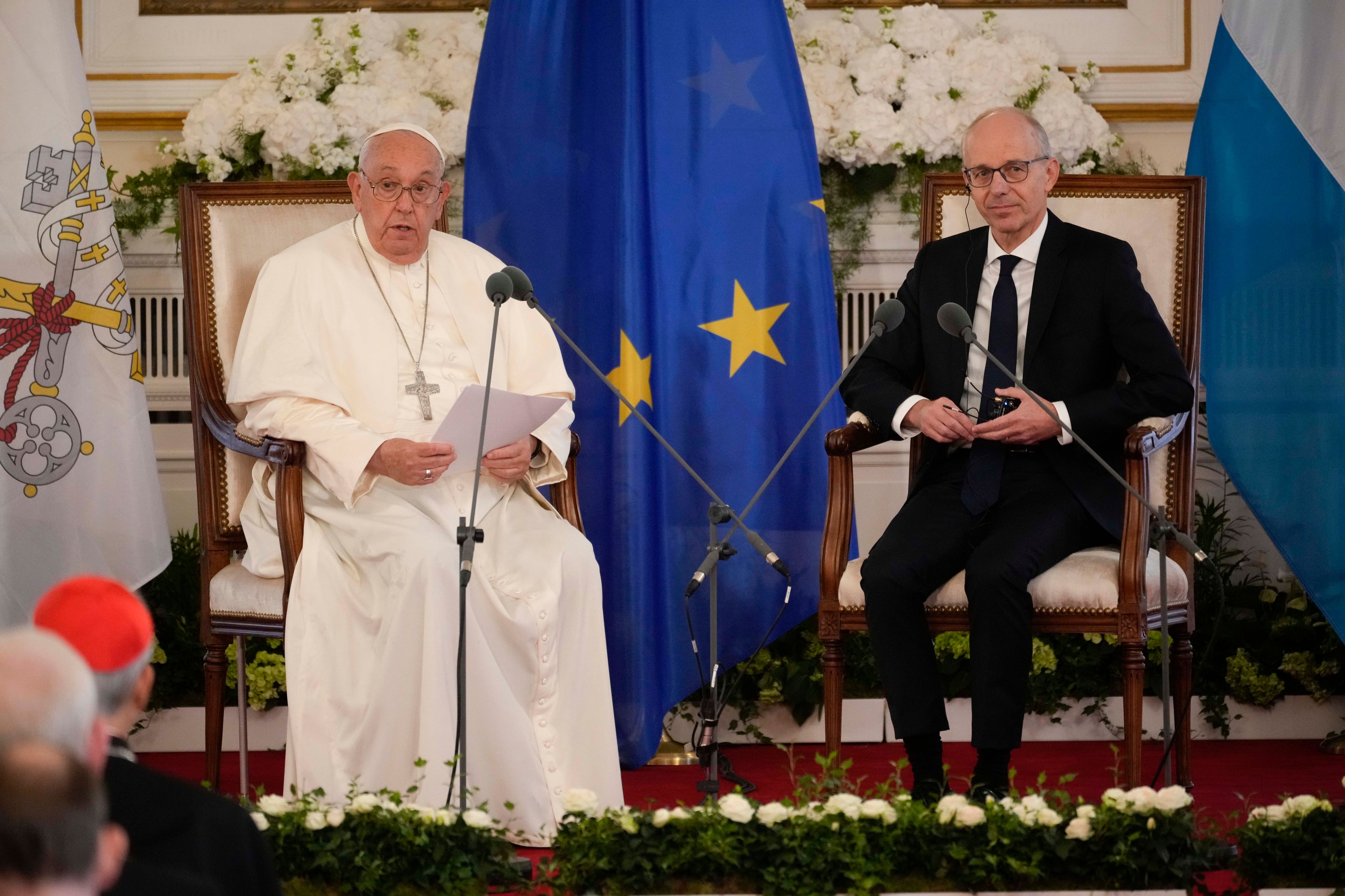 Pope Francis, flanked by Luxembourg's Prime Minister Luc Friede, meets with local authorities, the civil society, and the diplomatic corps in Luxembourg, Thursday, Sept. 26, 2024. (AP Photo/Andrew Medichini)