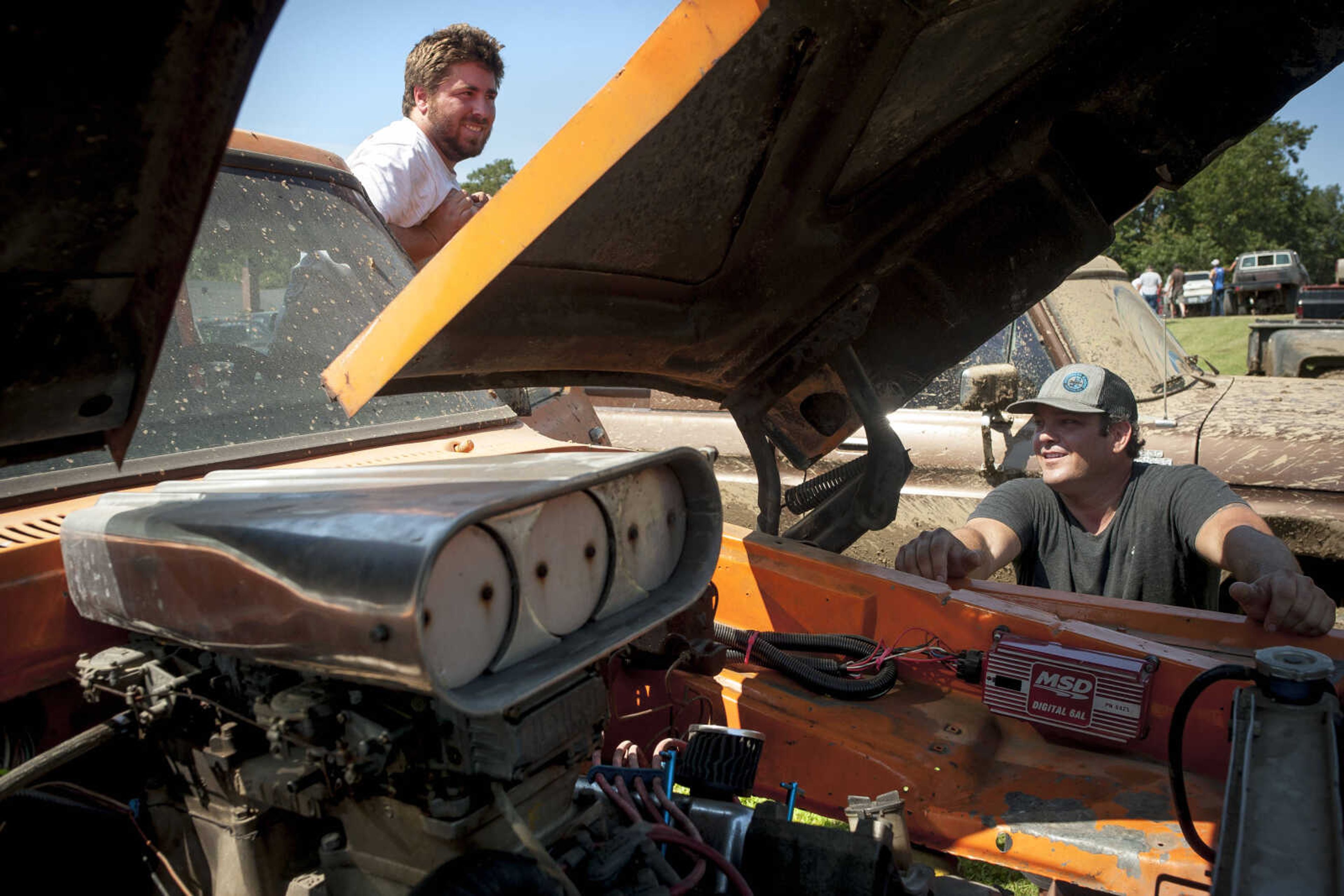 Boyd Thompson, left, and Jeff Hall work on Thompson's Ford Bronco at the annual mud races during Benton Neighbor Days  Saturday, Aug. 31, 2019 in Benton.