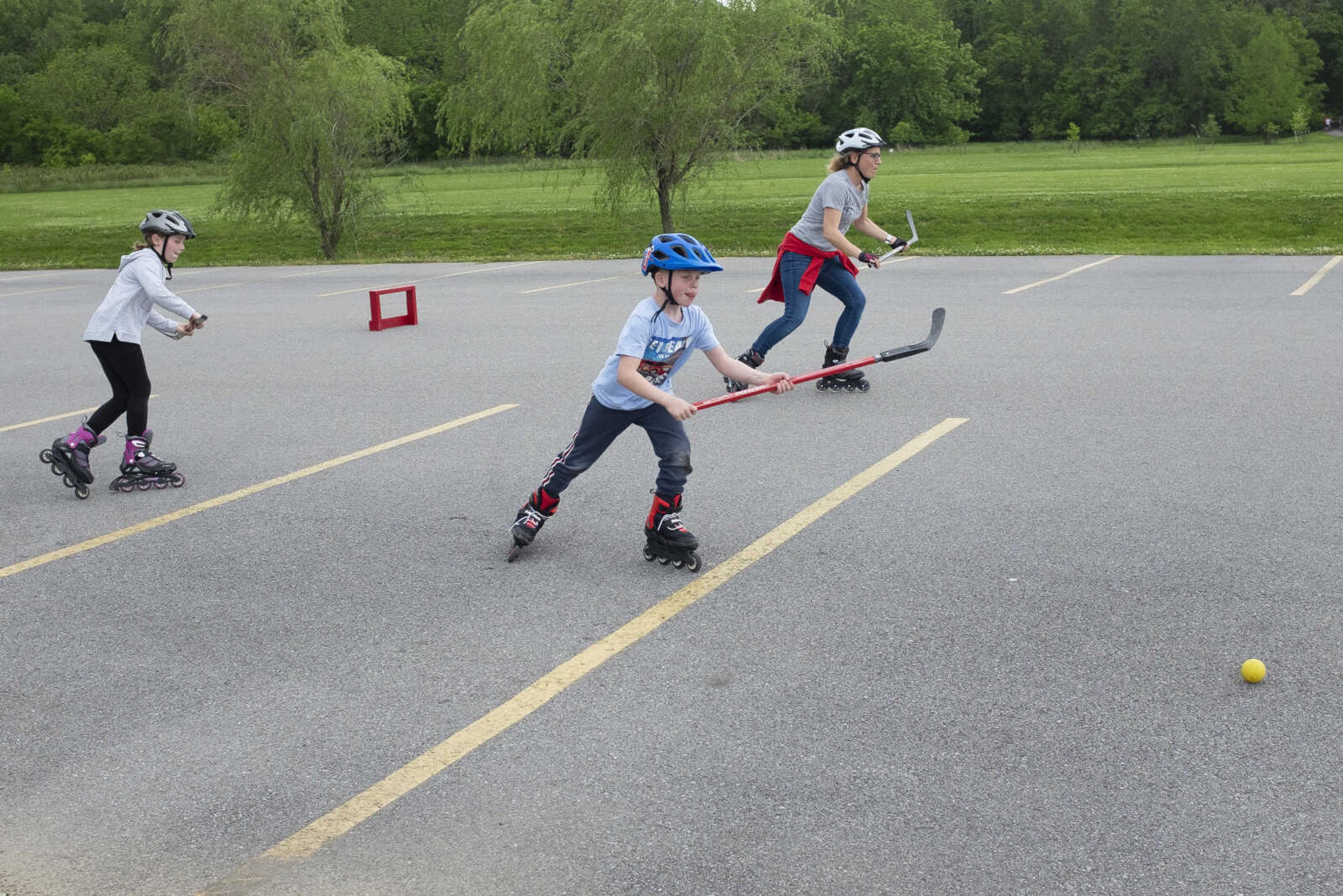 Henri Booch, 7, of Cape Girardeau goes after a ball near his mother Maren Booch (right) and sister Emma Booch, 9, on Wednesday, May 20, 2020, at a parking lot near Cape Splash Family Aquatic Center in Cape Girardeau.