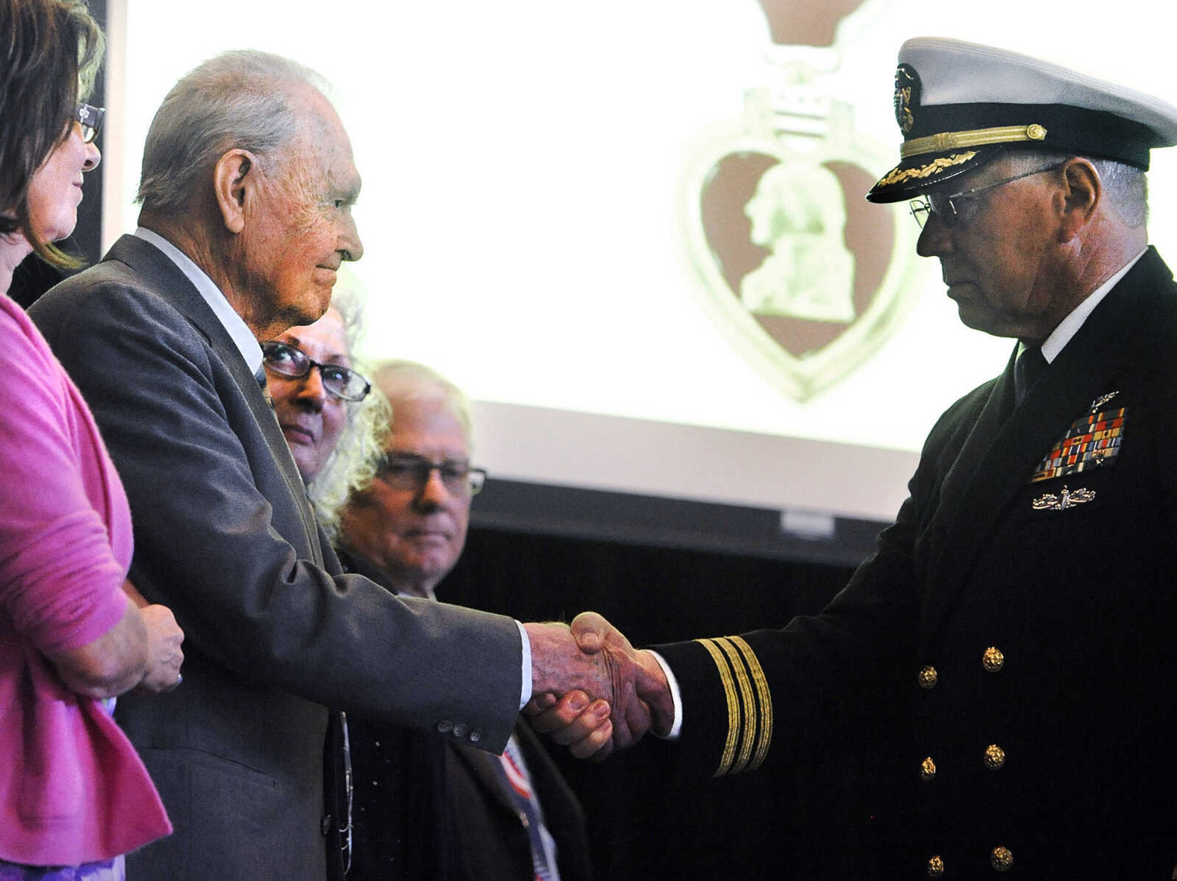 LAURA SIMON ~ lsimon@semissourian.com

Retired U. S. Navy Commander Lawson Burgfeld, right, shakes hands with U.S. Army Air Corps veteran Sgt. Clifford Heinrich after presenting Heinrich with a Purple Heart on Monday, March 21, 2016, at Alma Schrader Elementary in Cape Girardeau. Along with the Purple Heart, Heinrich was also presented with an American Campaign Medal, European-African-Middle Eastern Campaign Medal with Bronze Star, WWII Victory Medal, Army Good Conduct Medal and a WWII Lapel Button for his service during WWII.