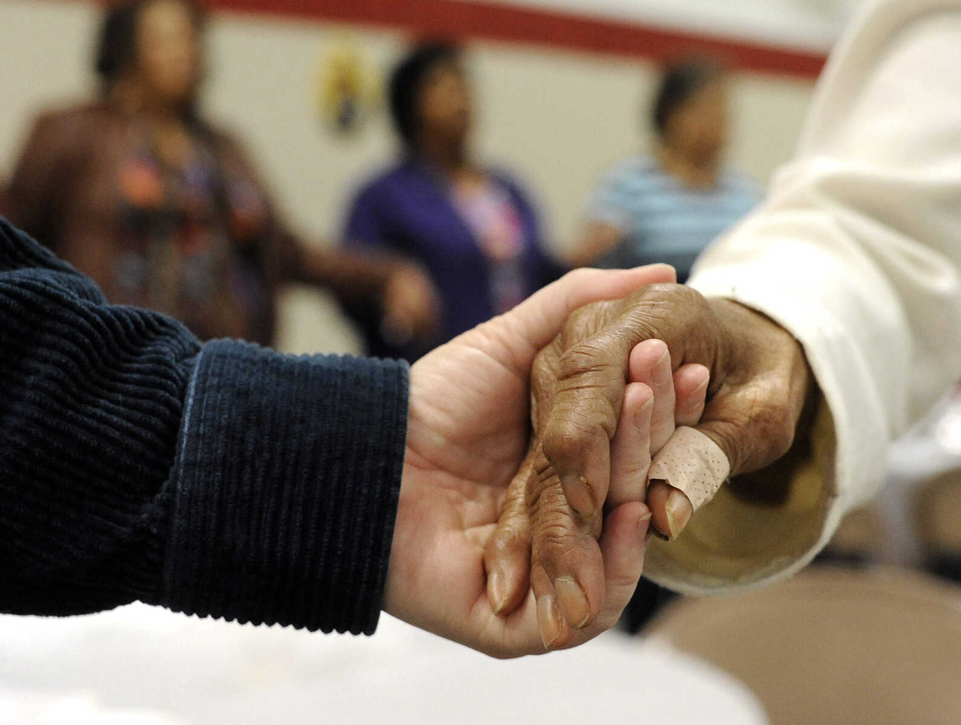 FRED LYNCH ~ flynch@semissourian.com
With hands clasped, the audience sings "God Bless America" at the close of the Dr. Martin Luther King Jr. Humanitarian Luncheon Monday, Jan. 19, 2015 at the Salvation Army in Cape Girardeau.