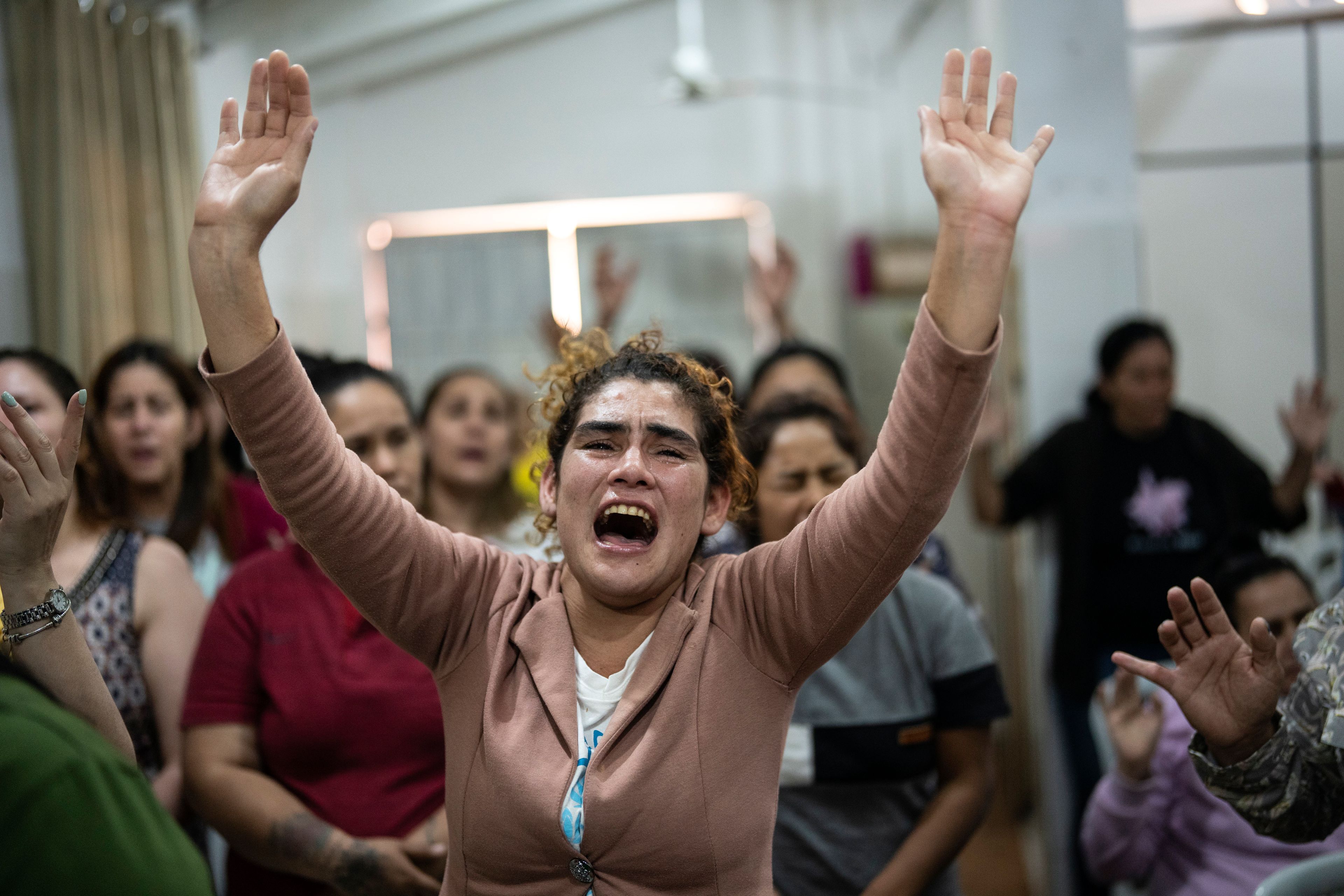 Inmates pray during an evangelical service at the Buen Pastor women's prison in Asuncion, Paraguay, Monday, Sept. 2, 2024. (AP Photo/Rodrigo Abd)