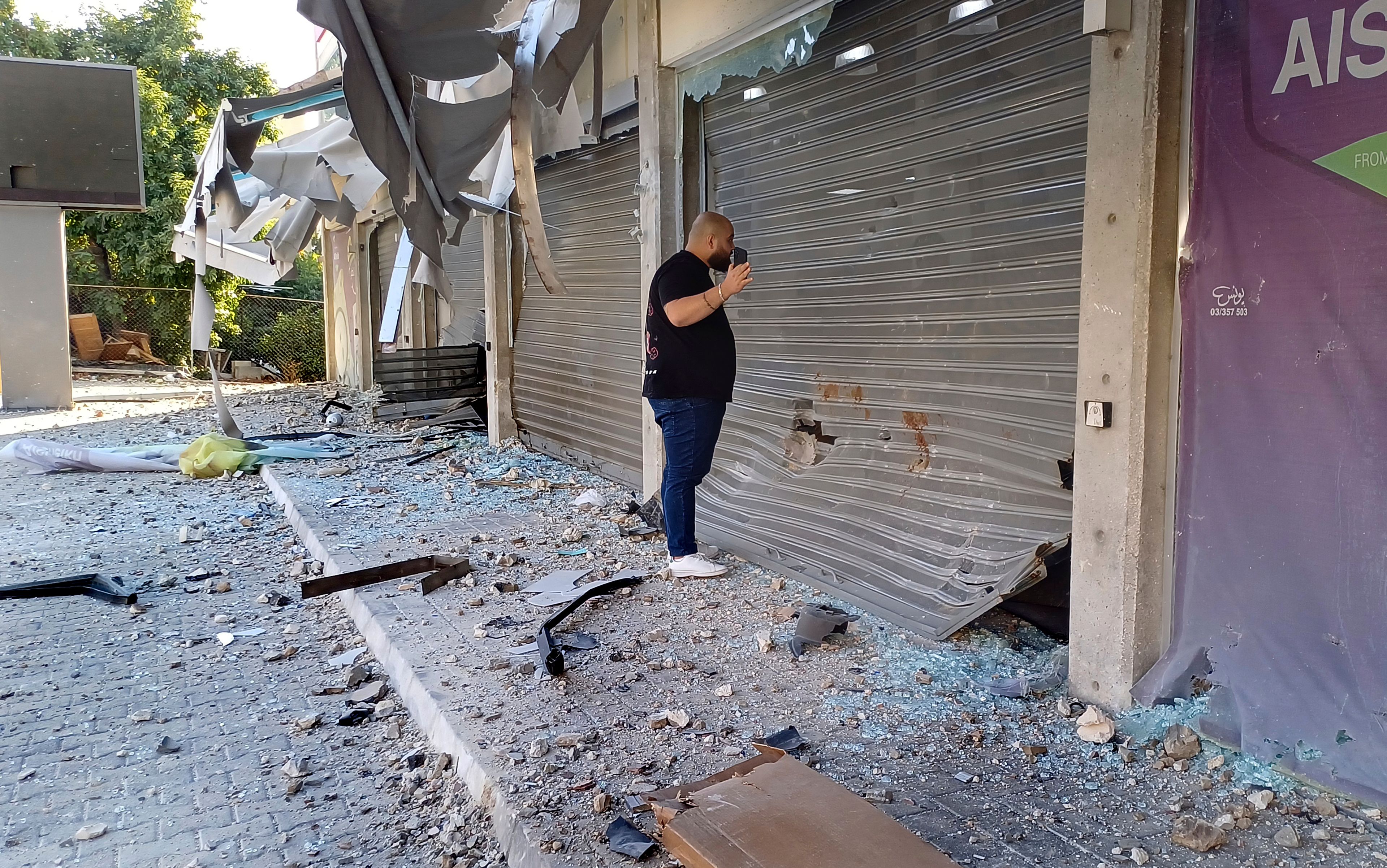 A man checks damaged shops at the site of an Israeli airstrike that hit a building, in the southern port city of Sidon, Lebanon, Sunday, Oct. 27, 2024. (AP Photo/Mohammed Zaatari)