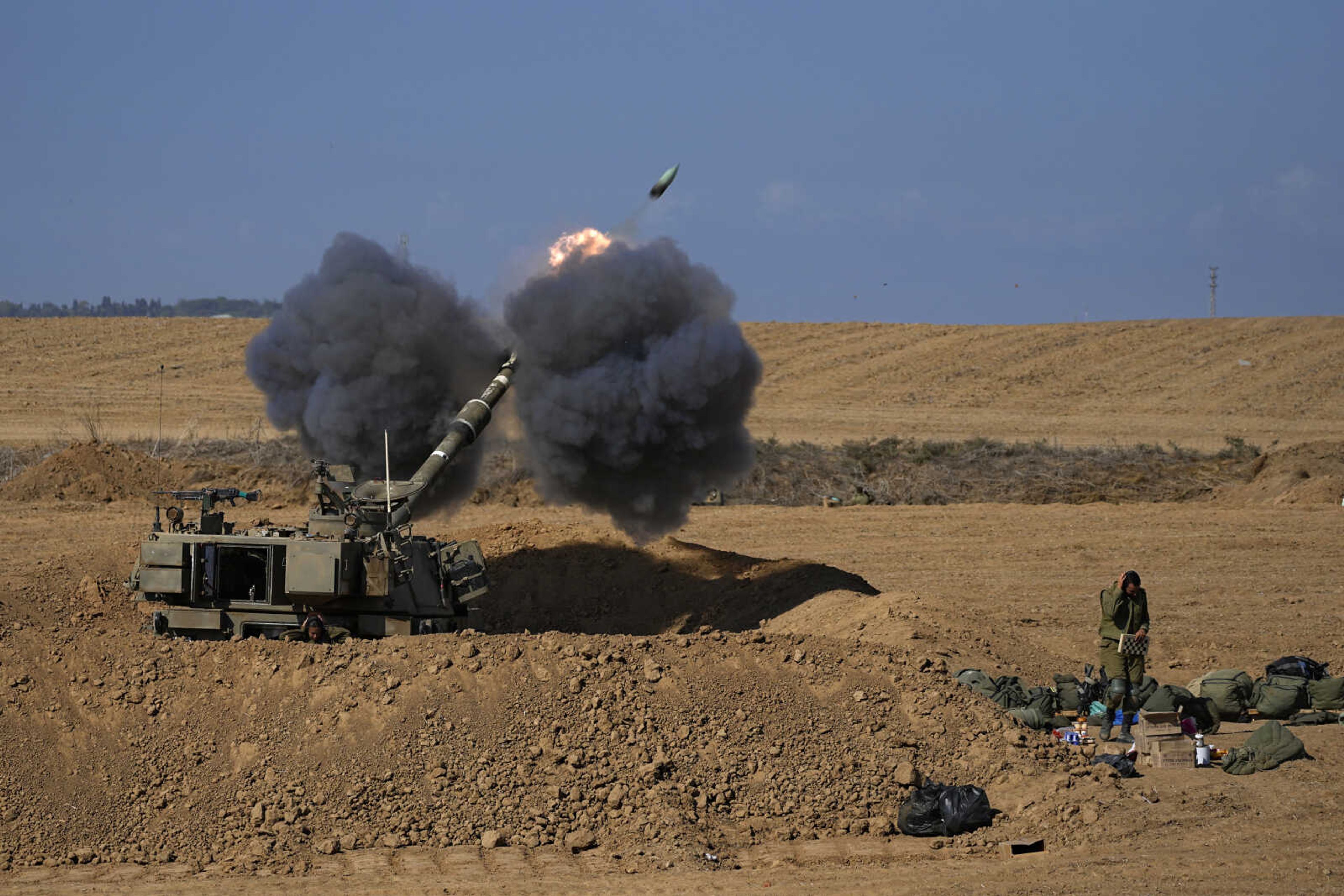 An Israeli mobile artillery unit fires a shell from southern Israel toward the Gaza Strip on Sunday in a position near the Israel-Gaza border.