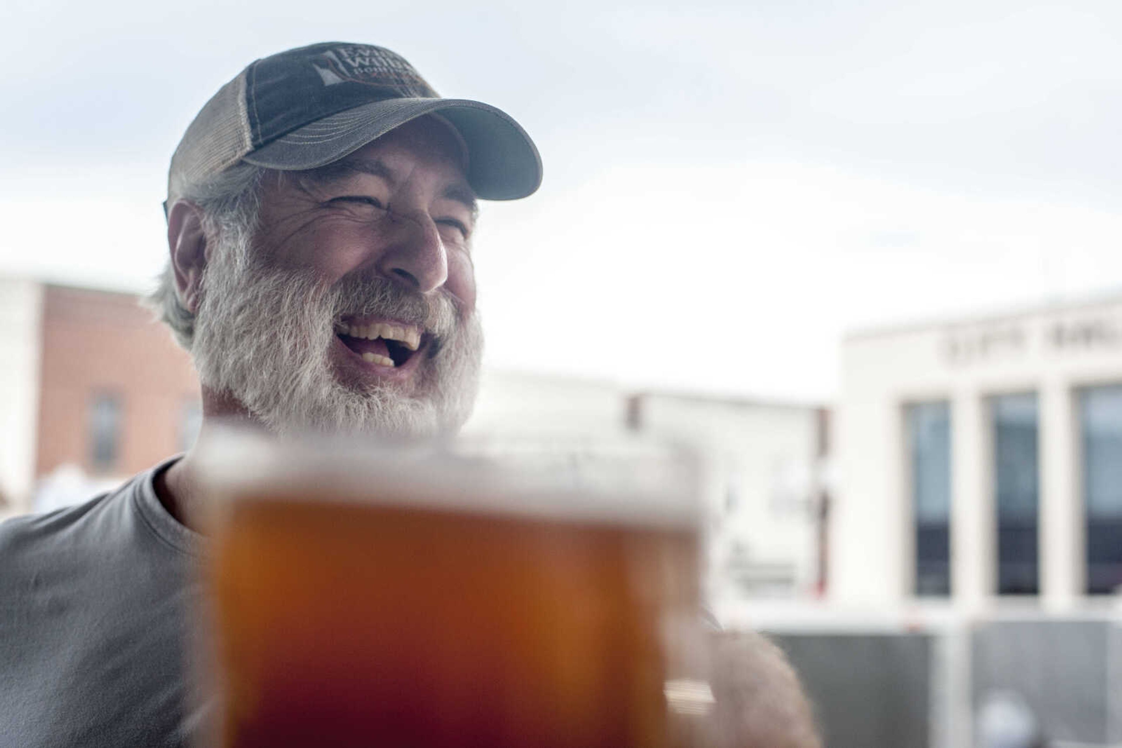 Paul Decanini laughs despite complaining of a burning in his arm as he tries to keep a bierstein aloft in a competition during Uptown Jackson Oktoberfest Saturday, Oct. 5, 2019, in Uptown Jackson.