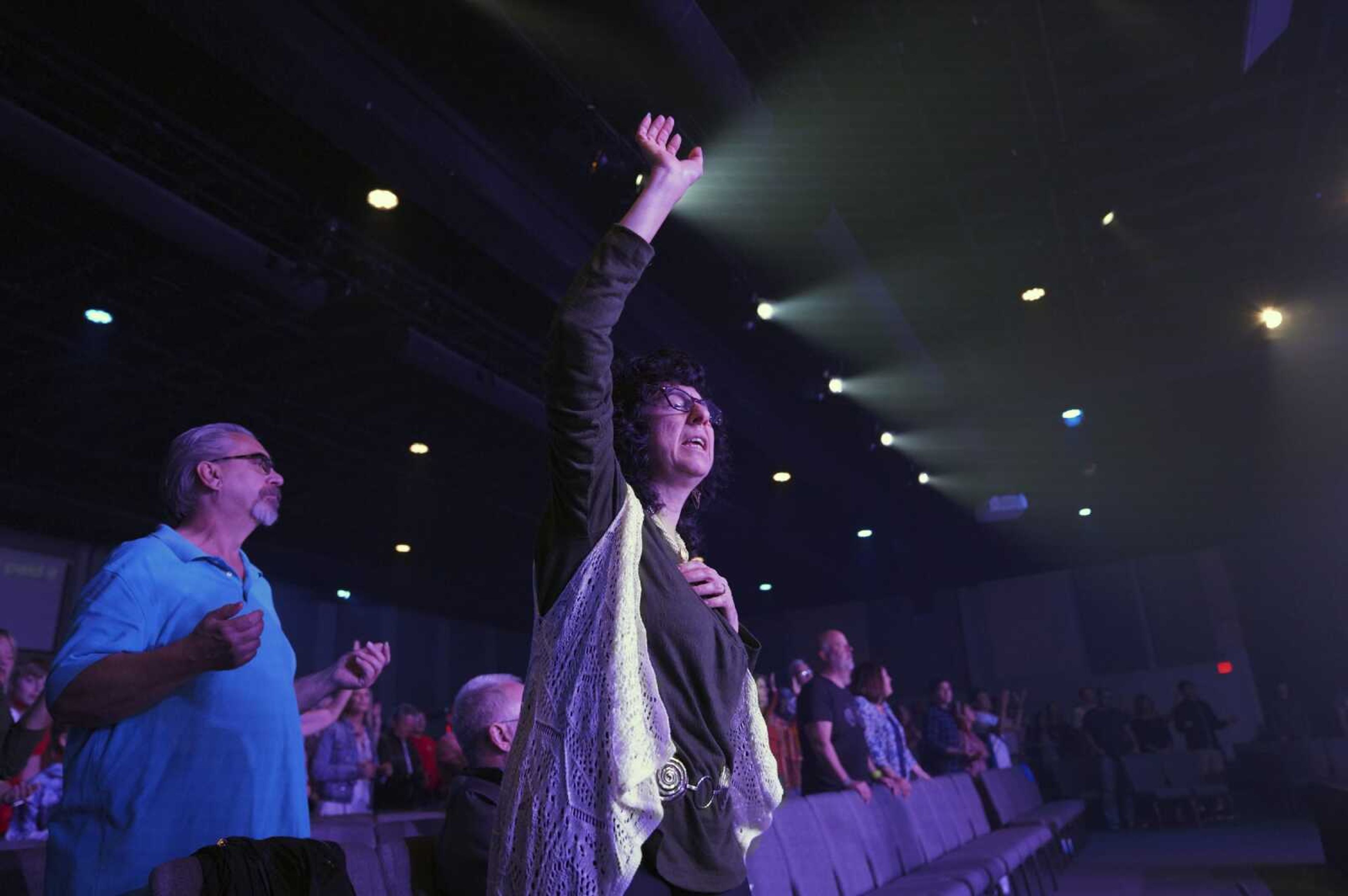 Parishioner Judy Perella raises her hand in worship during service at Allison Park Church on Sunday, Nov. 6, in Allison Park, Pennsylvania.