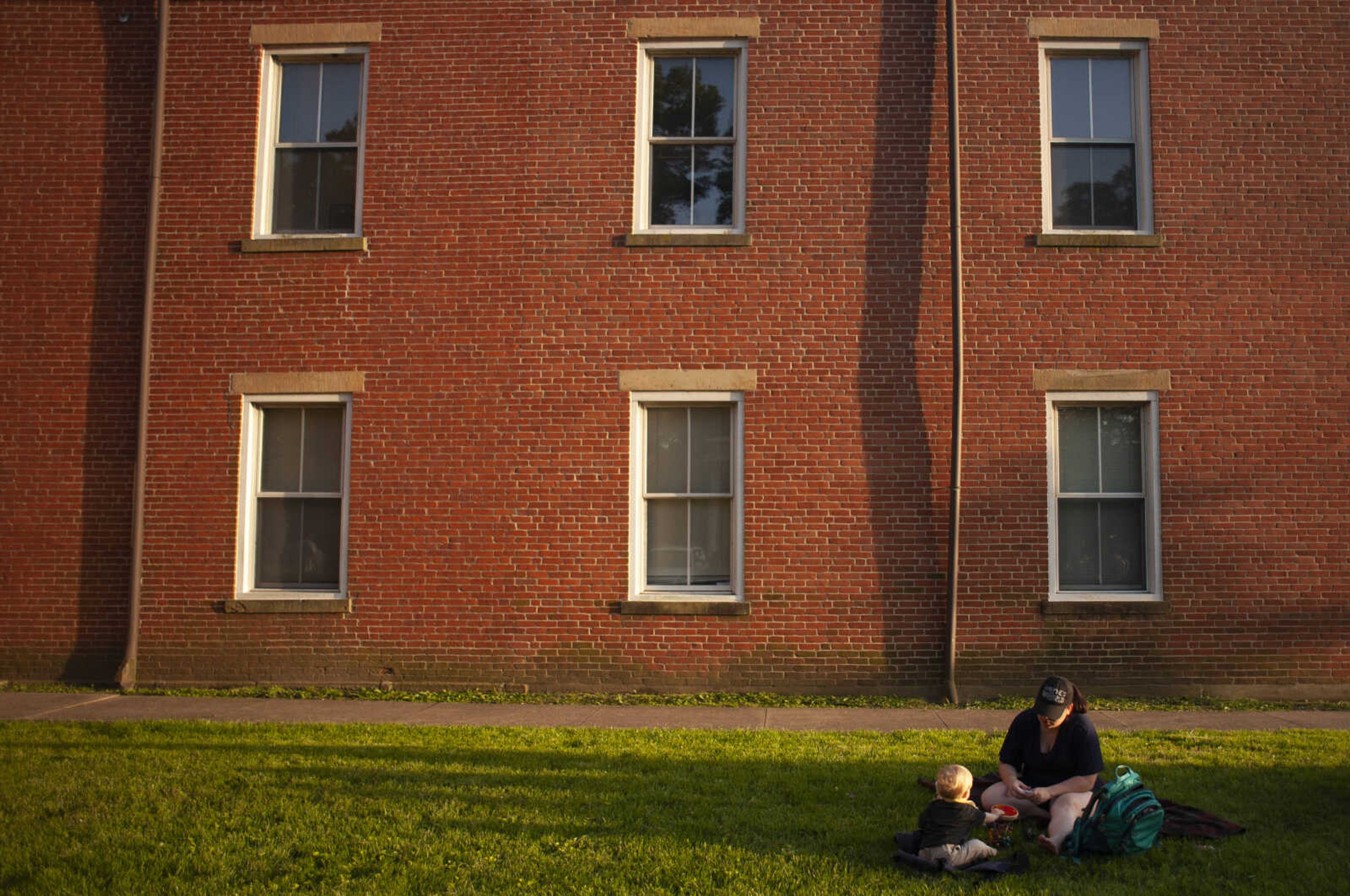 Lauren Clark Hill of Cape Girardeau sits with Peregrine Hill, 1, near Common Pleas Courthouse during the season's first Tunes at Twilight on Friday, May 17, 2019, at Ivers Square in Cape Girardeau.