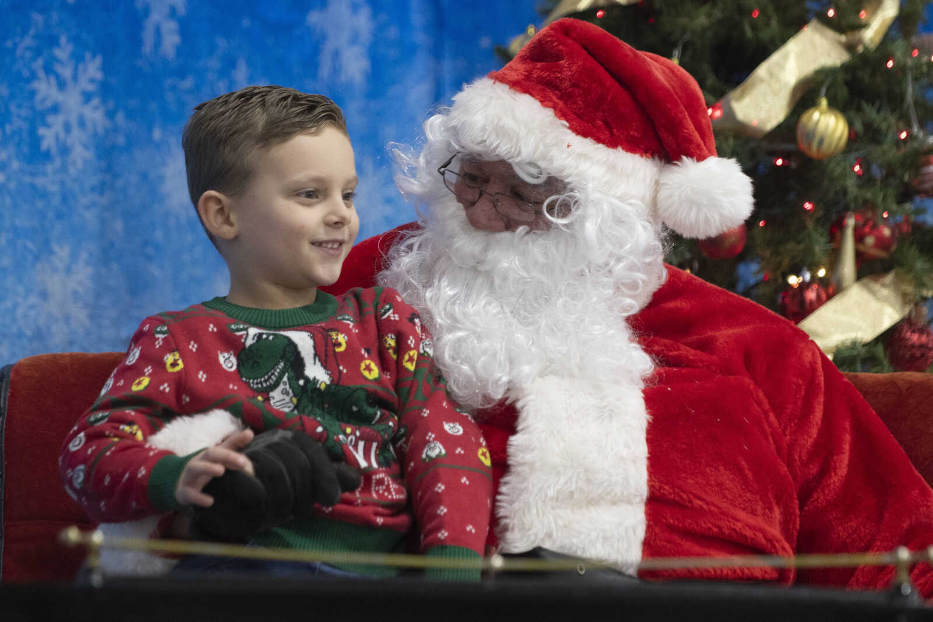 Chandler O'Connell, 4, of Altenburg, Missouri, meets with Santa Claus, portrayed by City of Cape Girardeau Parks &amp; Recreation parks division manager Brock Davis, during the Cape Parks &amp; Recreation Foundation's Breakfast with Santa event Saturday, Dec. 14, 2019, at the Osage Centre in Cape Girardeau.